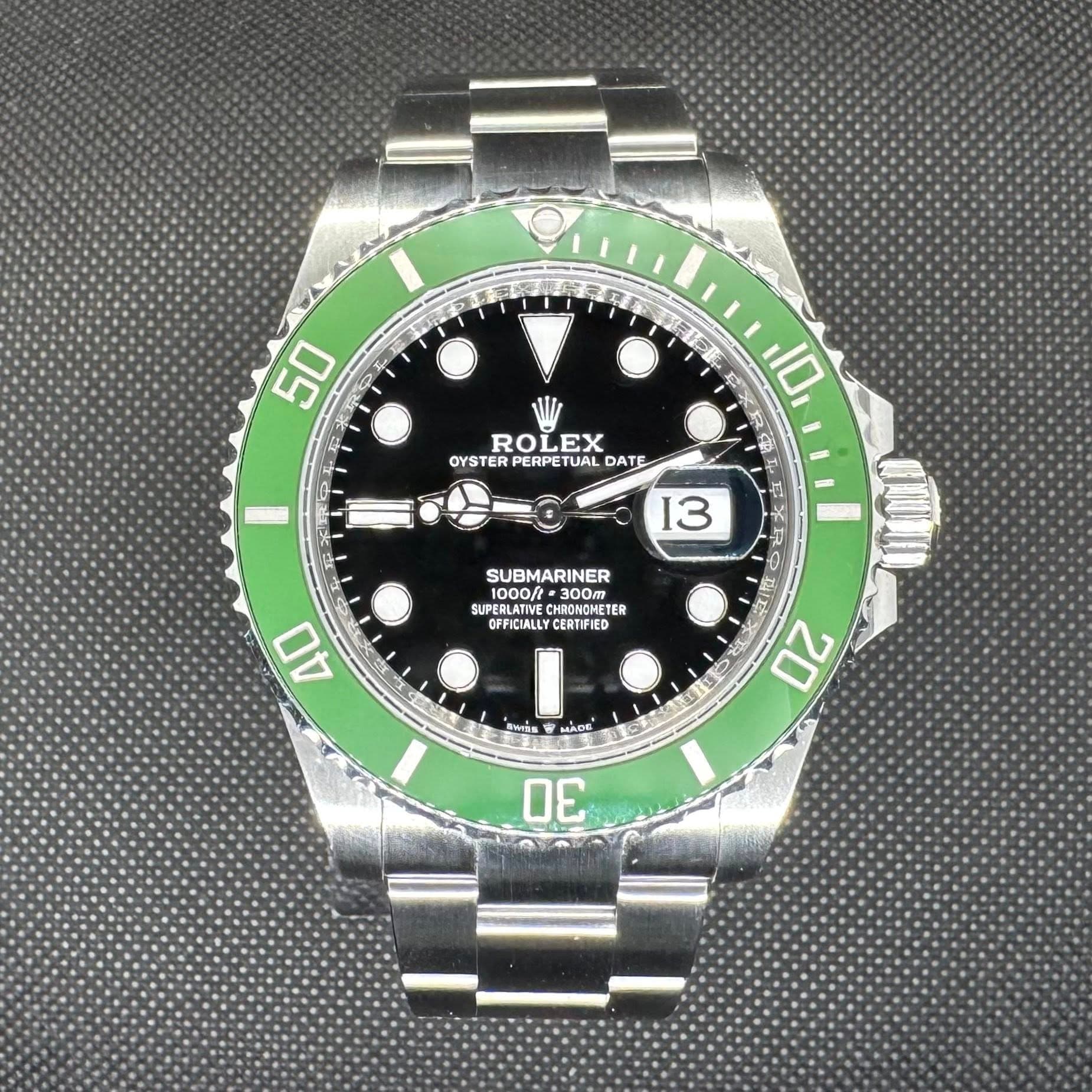 May be an image of wrist watch and text that says '50 ر แอ ROLEX EX ROL OYSTER PERPET OYSTERPERPETUALD TUAL DATE 10 I 13 SUBMARINER 1000/t =300m 0O ER SUPERLATIVE…