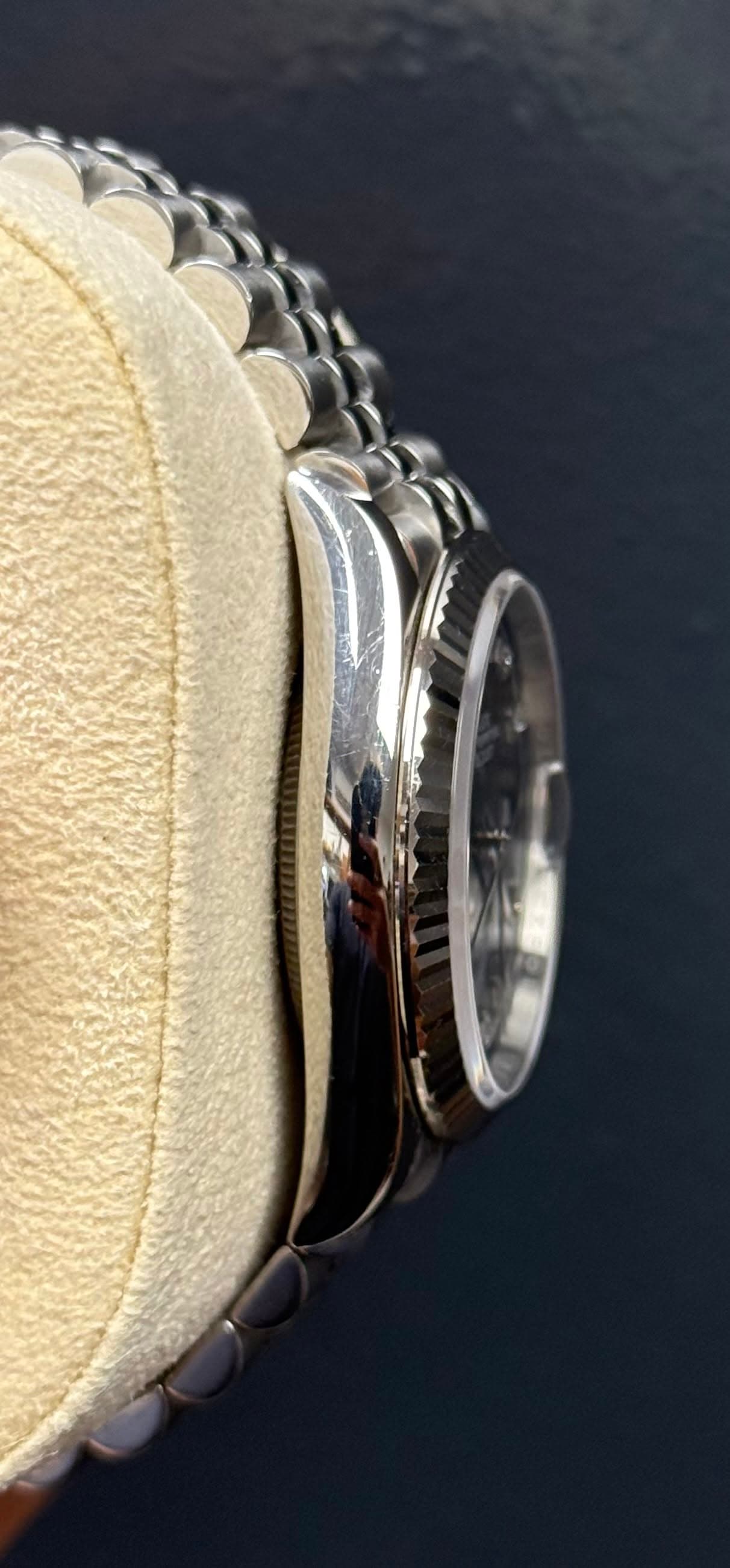 May be an image of saddle-stitched leather, leather and wrist watch