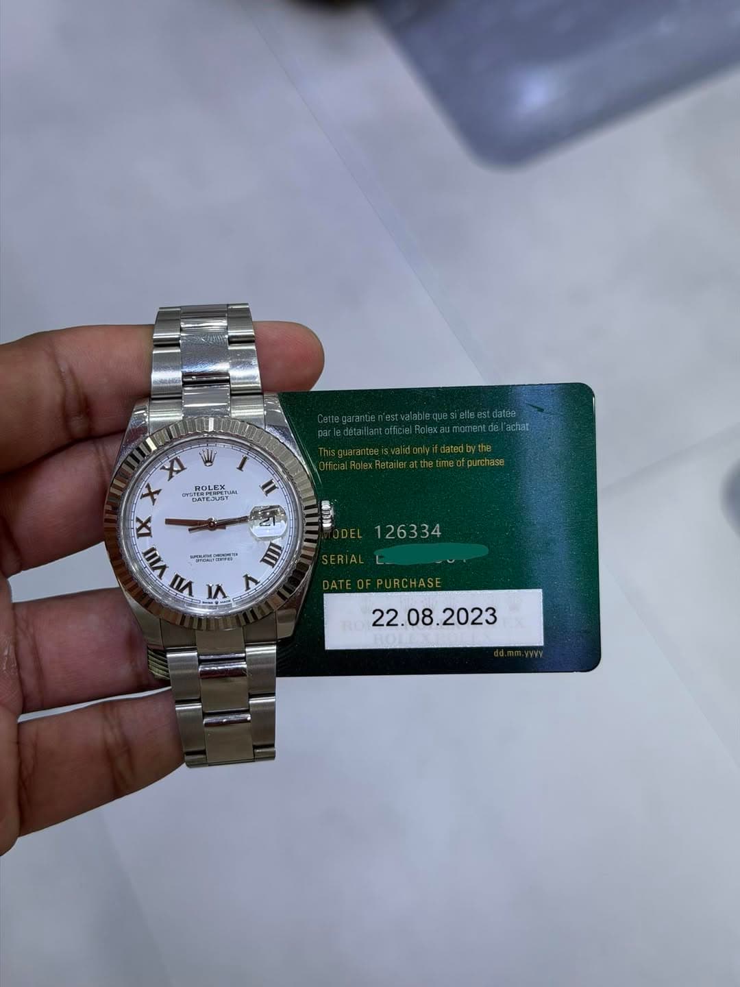 May be an image of wrist watch and text