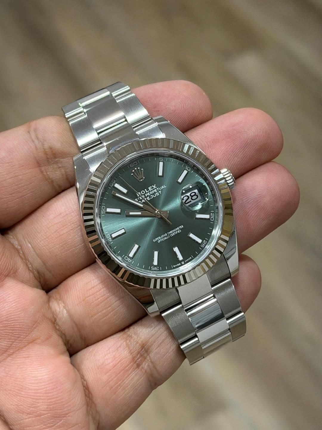 May be an image of wrist watch and text