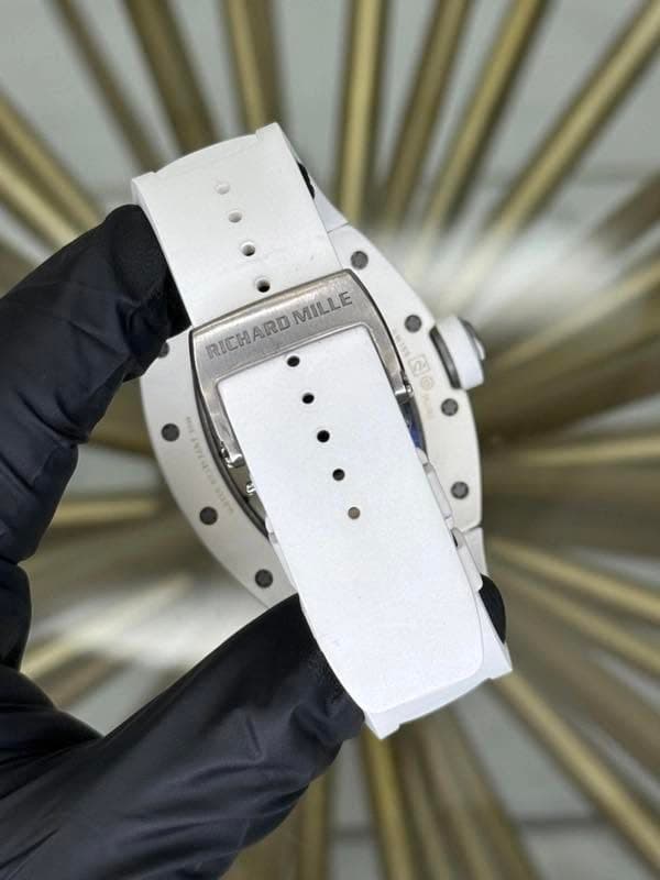 May be an image of wrist watch and text that says 'RICHARD RD RICHARD MILLE MILLE ៣ S0E TANT'