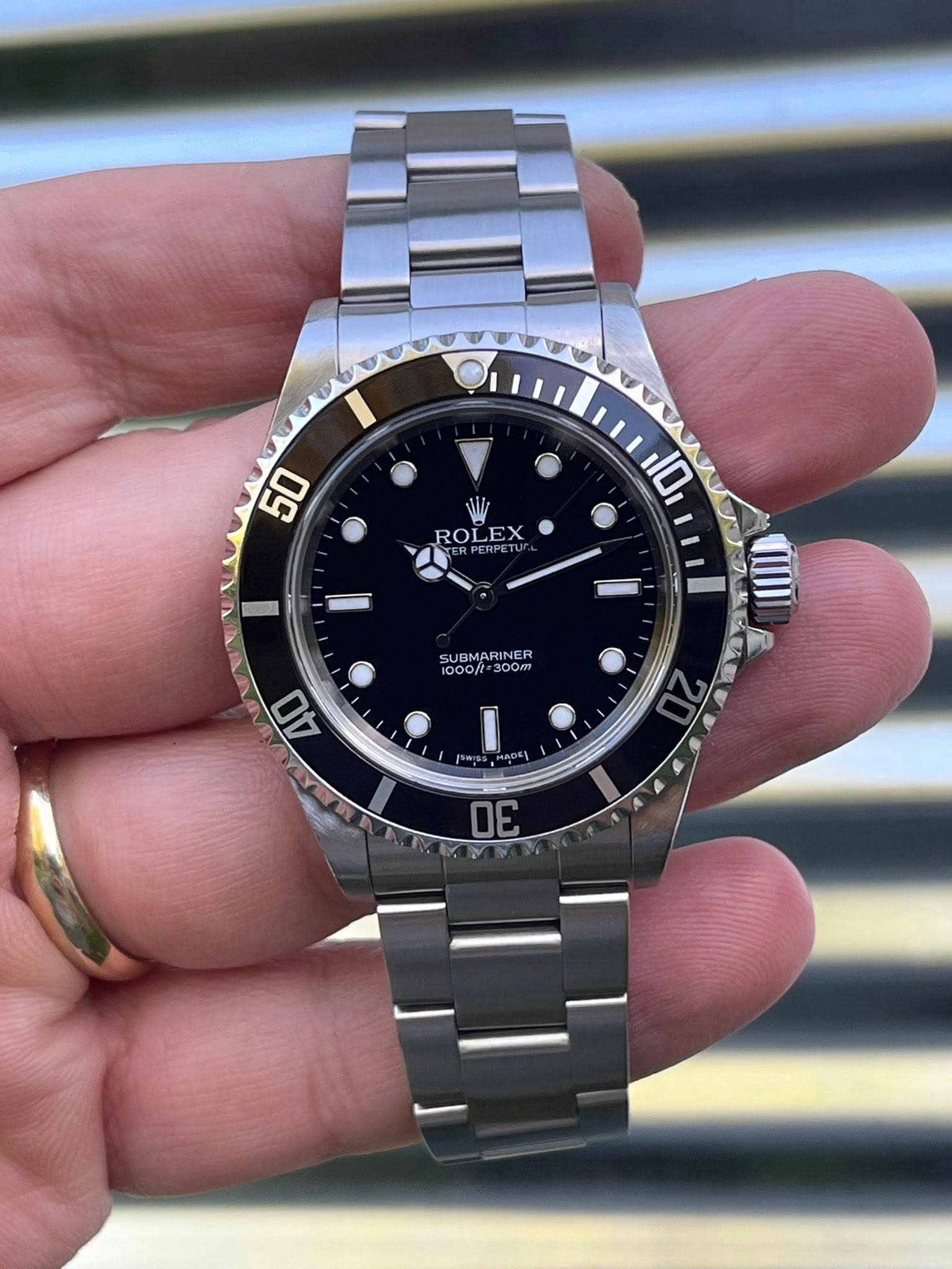 May be an image of wrist watch and text that says '50 ROLEX EX ROL ERPERPET 10 V SUBMARINER 1000/ 1000/r*300m 300m 40 SWI ADE 2 30'
