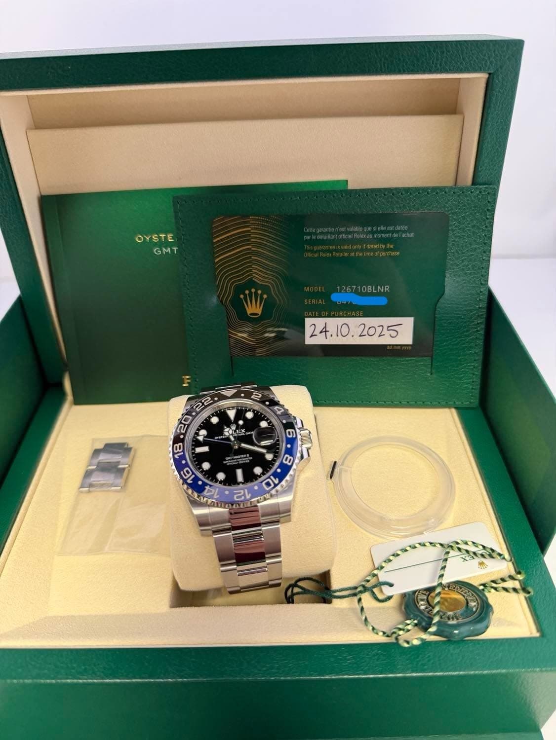 May be an image of wrist watch and text that says 'OYSTE GMT 126710BLNR W ወ V n 14 12 ቤንራ'