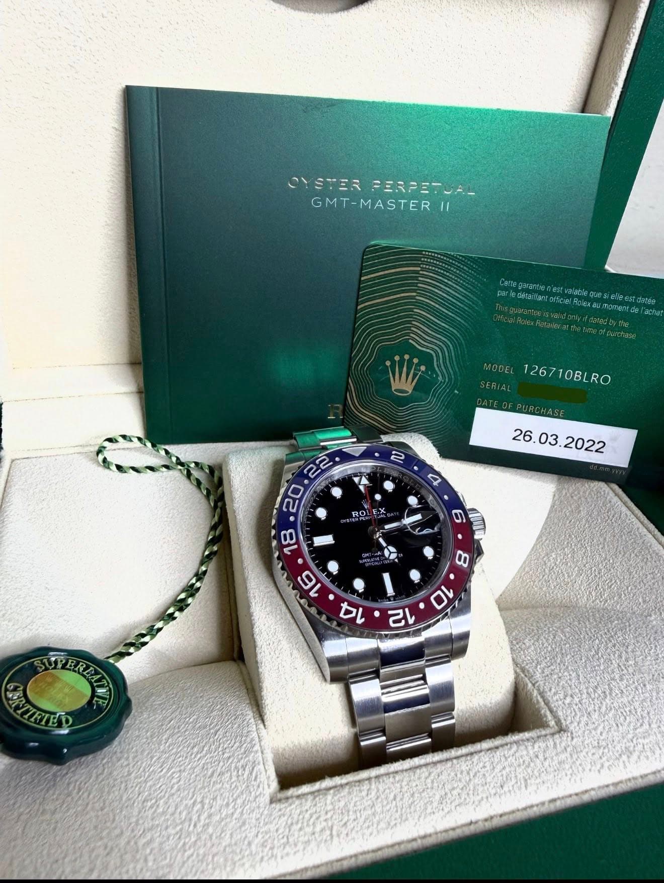 May be an image of wrist watch and text that says 'CYSTERPESPE-. YSTER FERPETUA_ GMT-MASTER MODEL 126710BLRO K ROL X e 6 S 8 10 12 TEREE PEREAT AaTKTp'