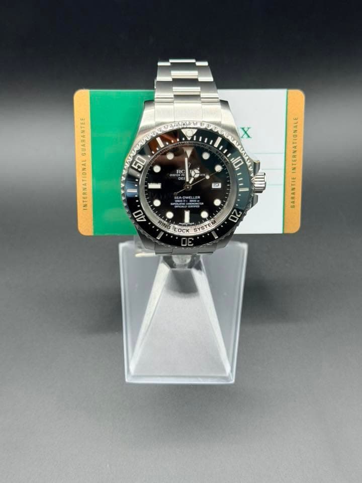 May be an image of wrist watch and text that says 'X E GUARANTEE NTERNATIONAL 50 HC RC 10 19 BA-OWELLER SPILEMCIRINONG 40 NIN INTERNATIONALE RAN SARANTIE LOCK 20'