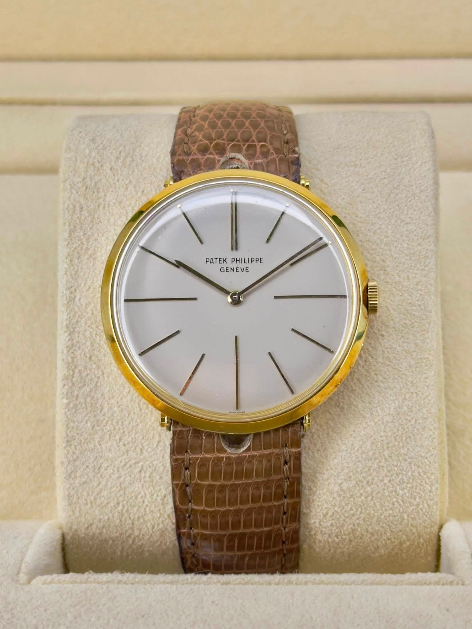 May be an image of leather, wrist watch and text that says 'PATEKPHILIPPE PATEK PHILIPPE PHILI GENEVE'
