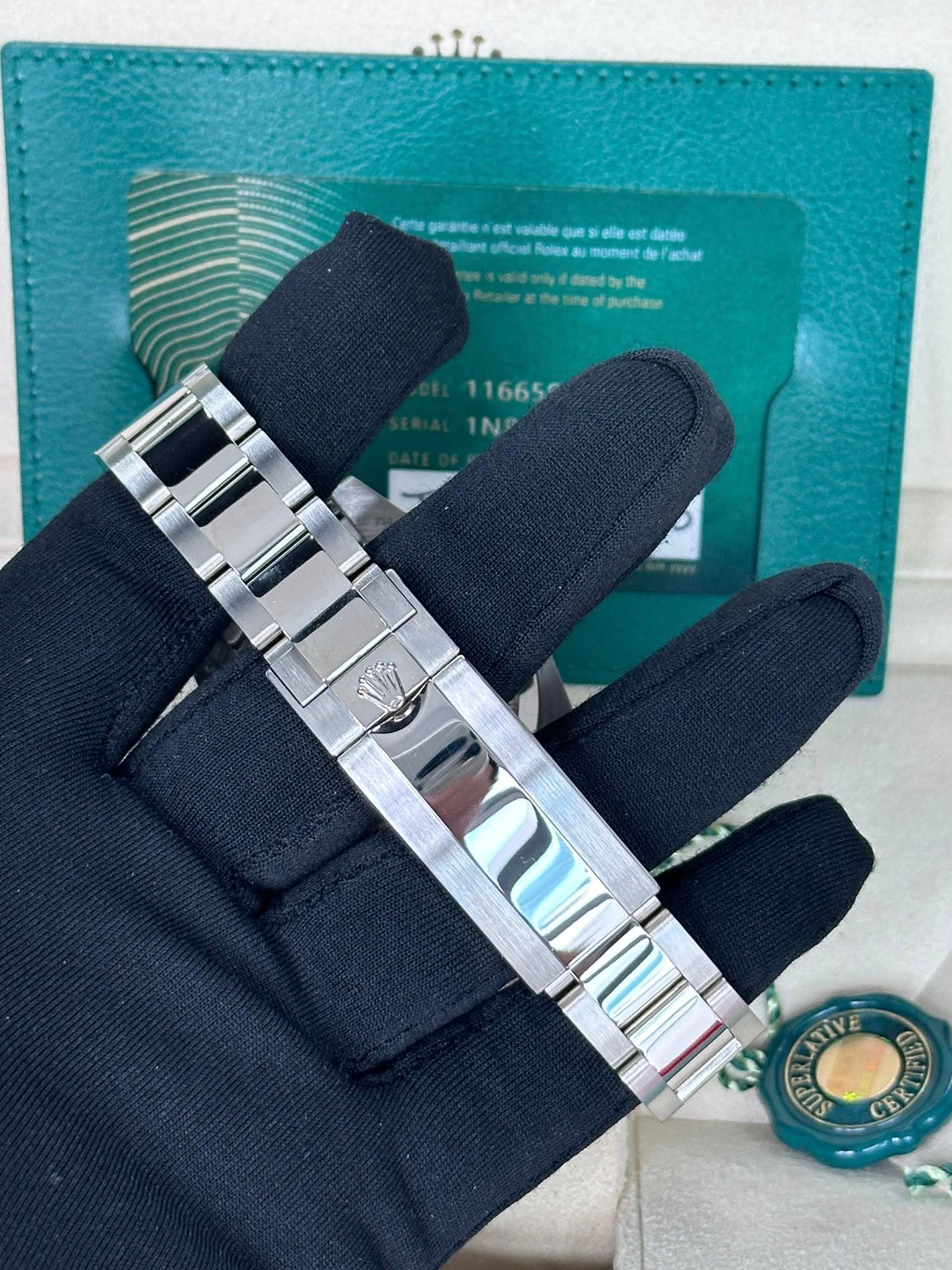 May be an image of leather wallet, leather, wrist watch and text