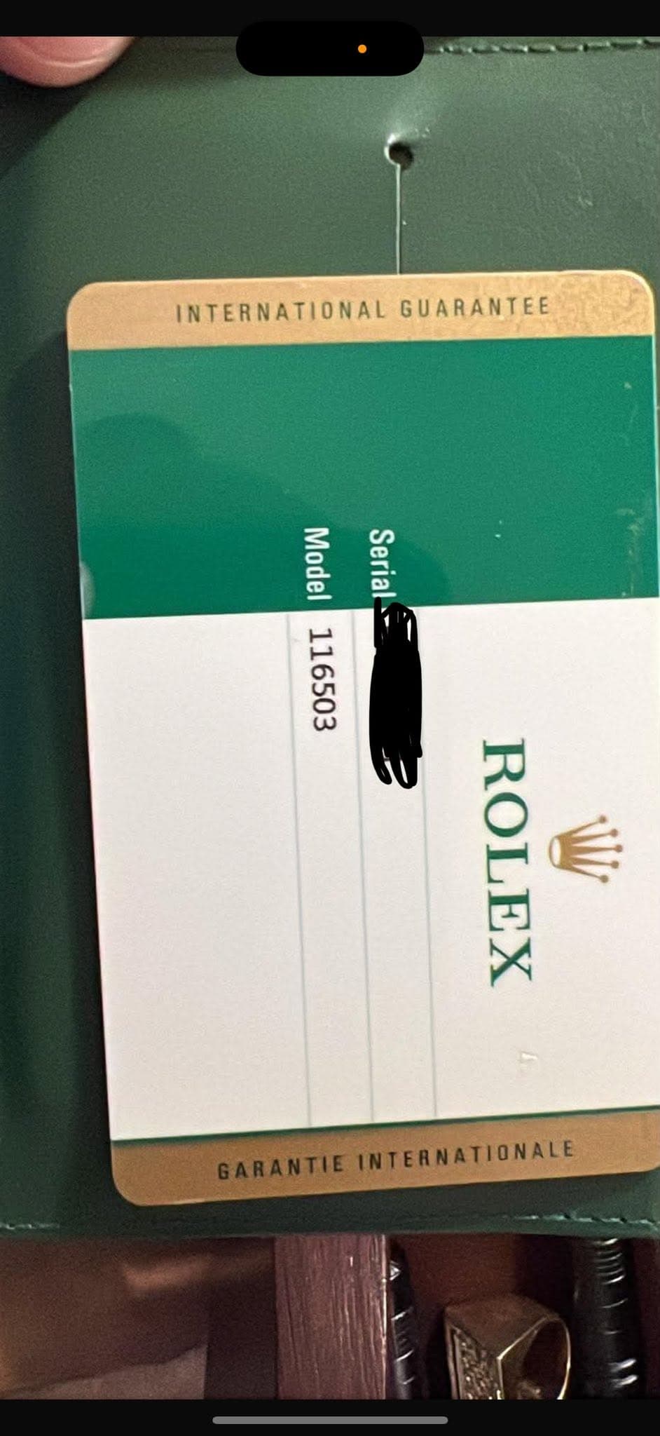 May be an image of ticket stub and text that says 'INTERNATIONALGUARANTEE INTERNATIONAL GUARANTEE Model Serial 116503 ROLEX W GARANTIE GARANTIEINTERNATIONALE INTERNATIONALE'