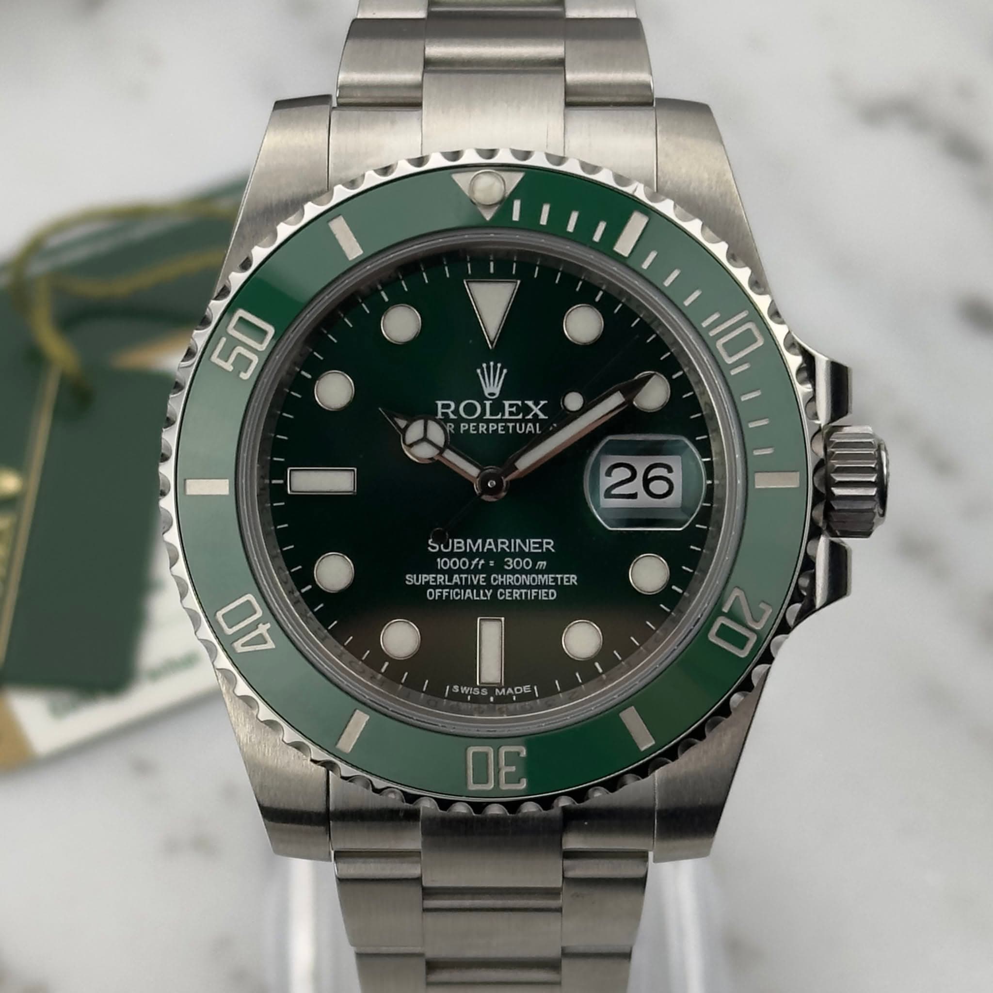 May be an image of wrist watch and text that says '50 ROLEX RPERPETUAL HA 10 26 SUBMARINER /: 300m SUPERLATI HRONOMETER TER OFFICIALLY OFFICIALLYCERTIFIED PFIGTALLYCERTIFIED…