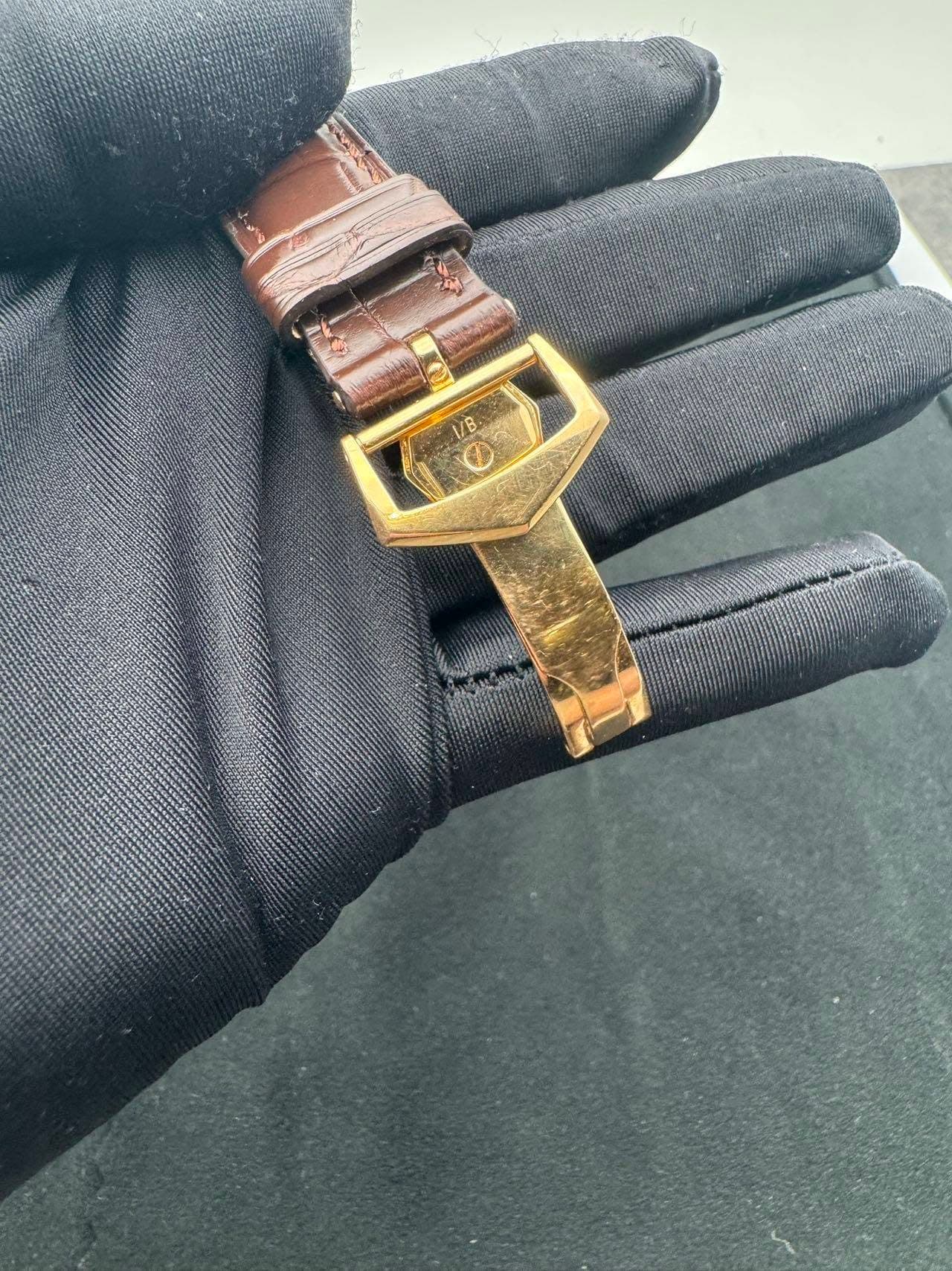 May be an image of saddle-stitched leather, leather and wrist watch