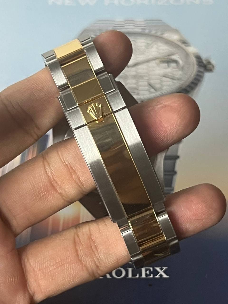 May be an image of wrist watch and text that says 'LOLEX'