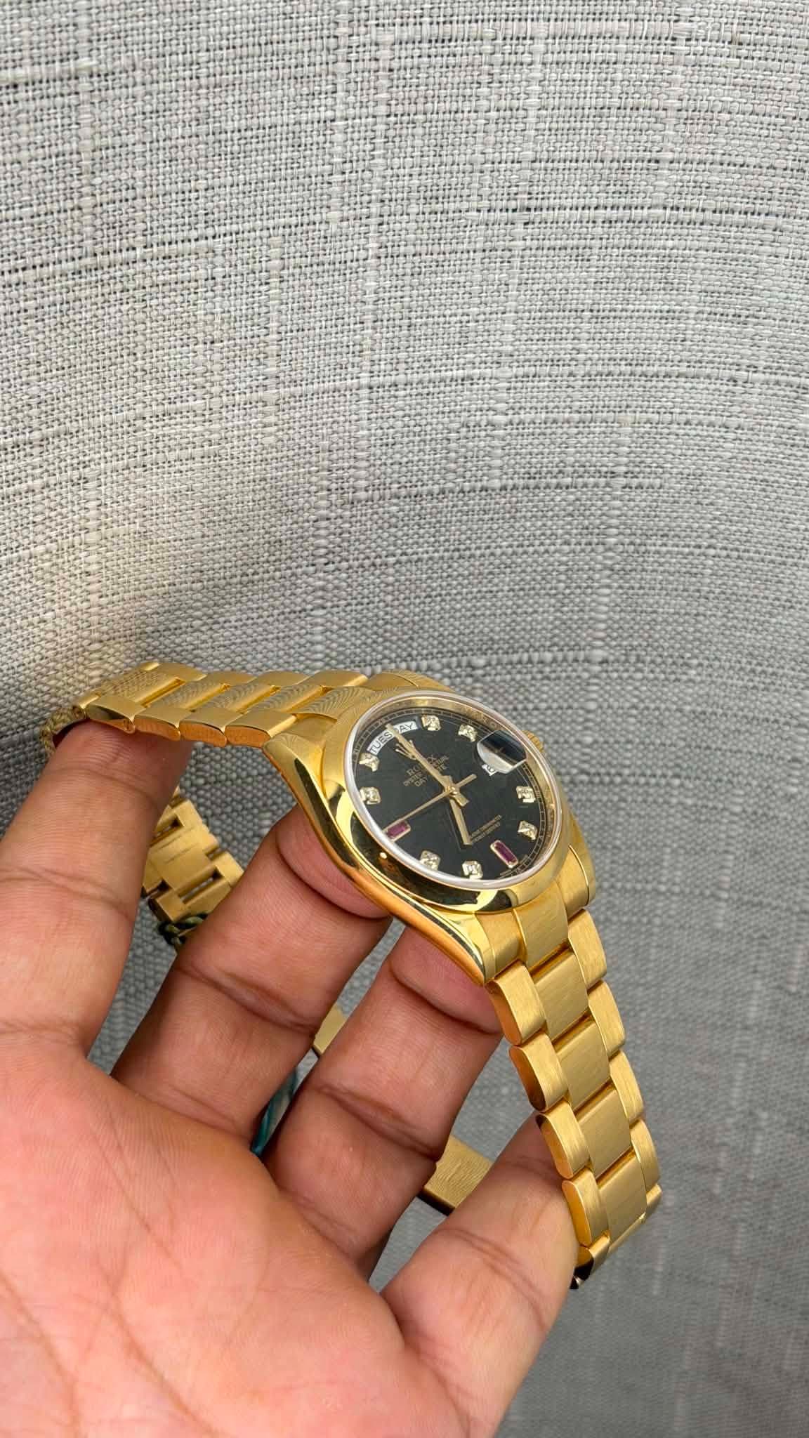 May be an image of wrist watch and text