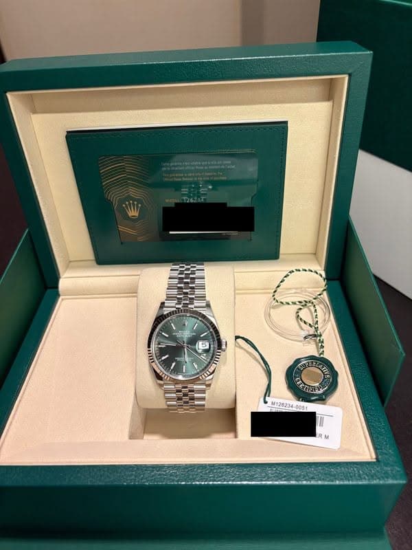 May be an image of wrist watch and text