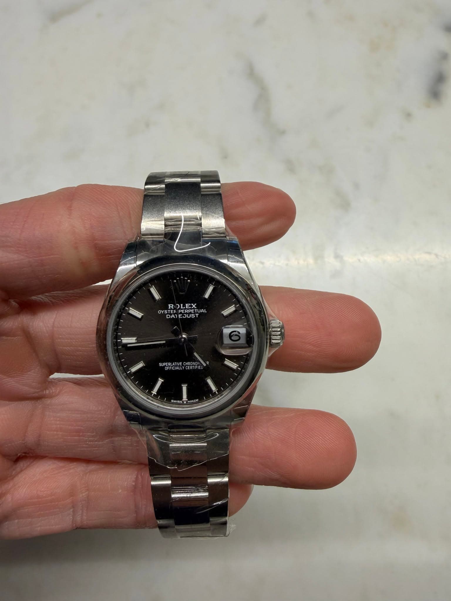 May be an image of wrist watch and text
