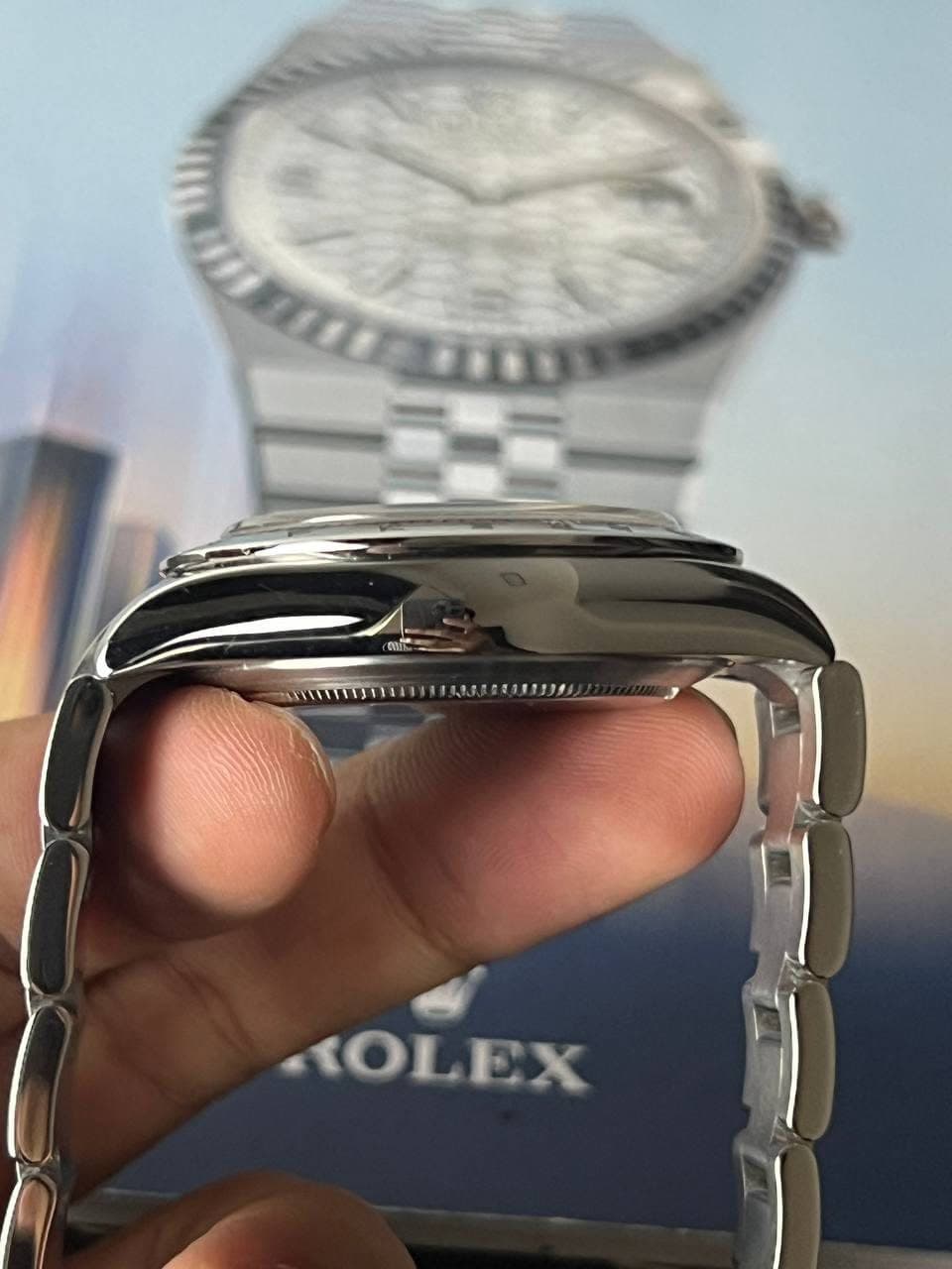 May be an image of wrist watch and text