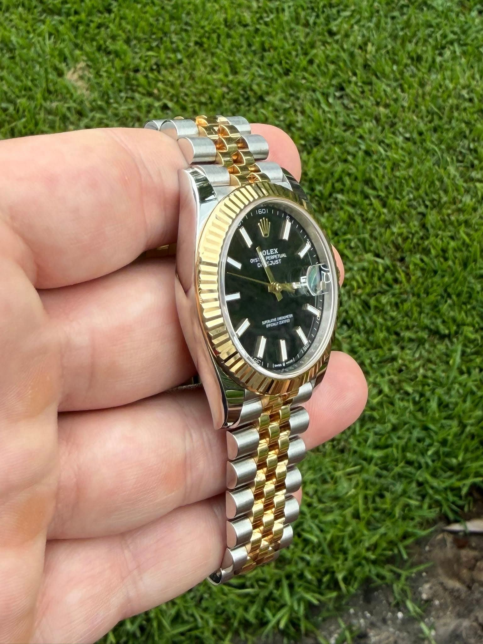 May be an image of wrist watch and text