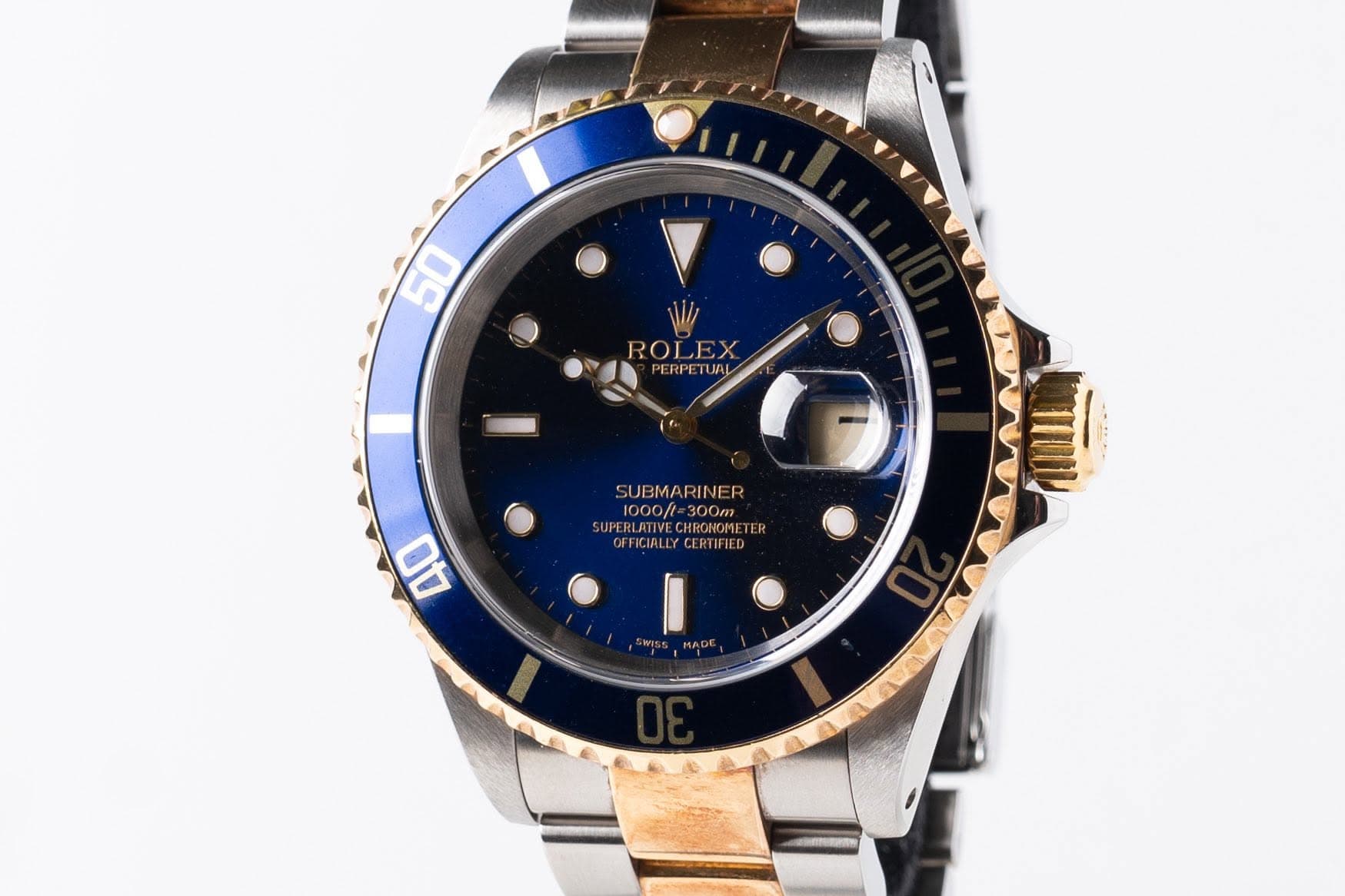May be an image of wrist watch and text that says '50 ROLEX PERPETUAL SUBMARINER 1000/t -300m SUPER SUPERLATIVE.CHRCNOME TER CHRONOME OEFICIALLYCERTIFIED IALL CEH 40'