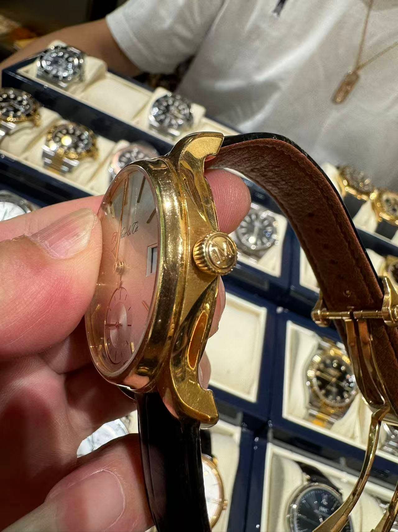 May be an image of wrist watch and text