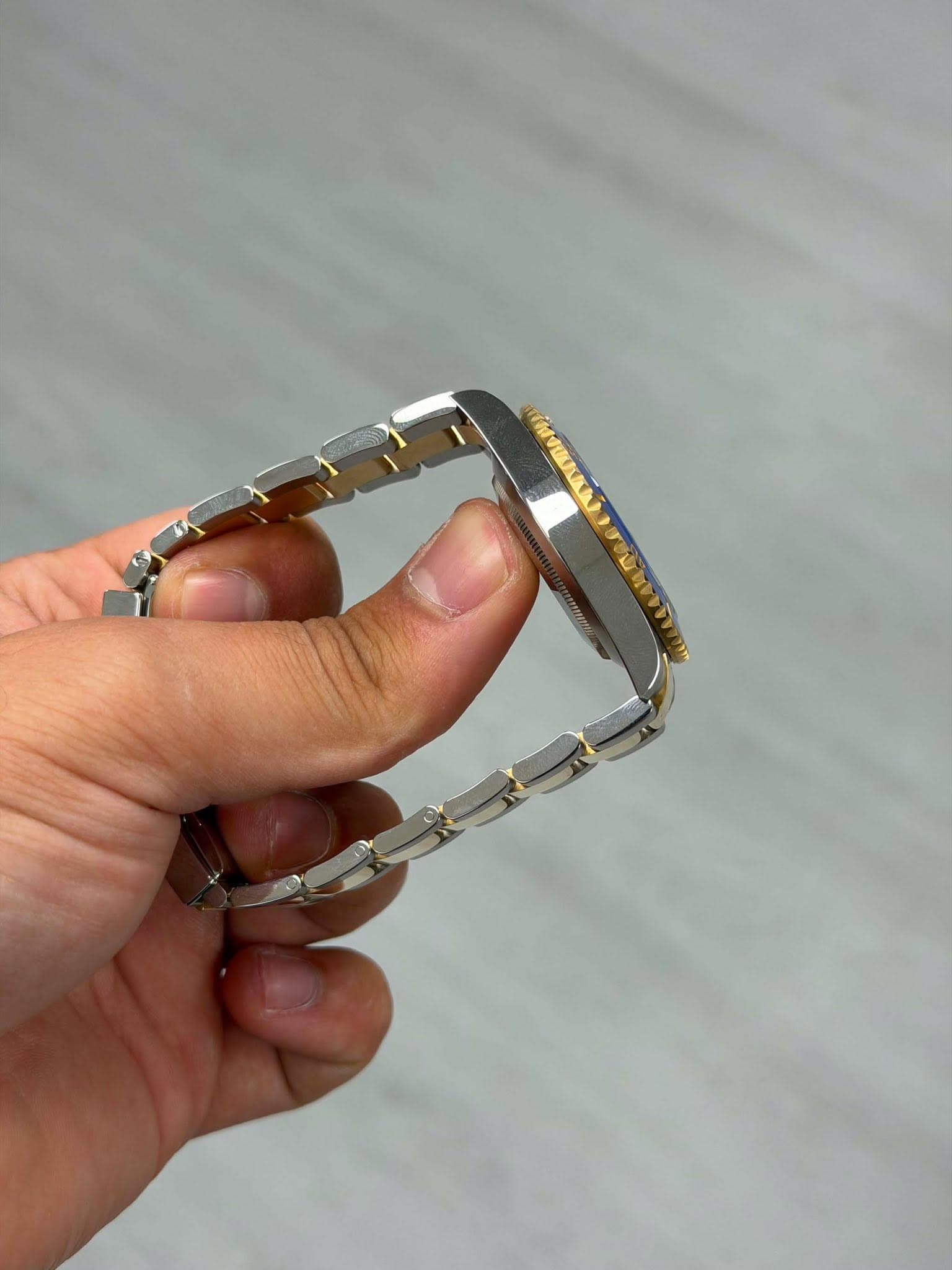 May be an image of eyeglasses, jewelry and wrist watch