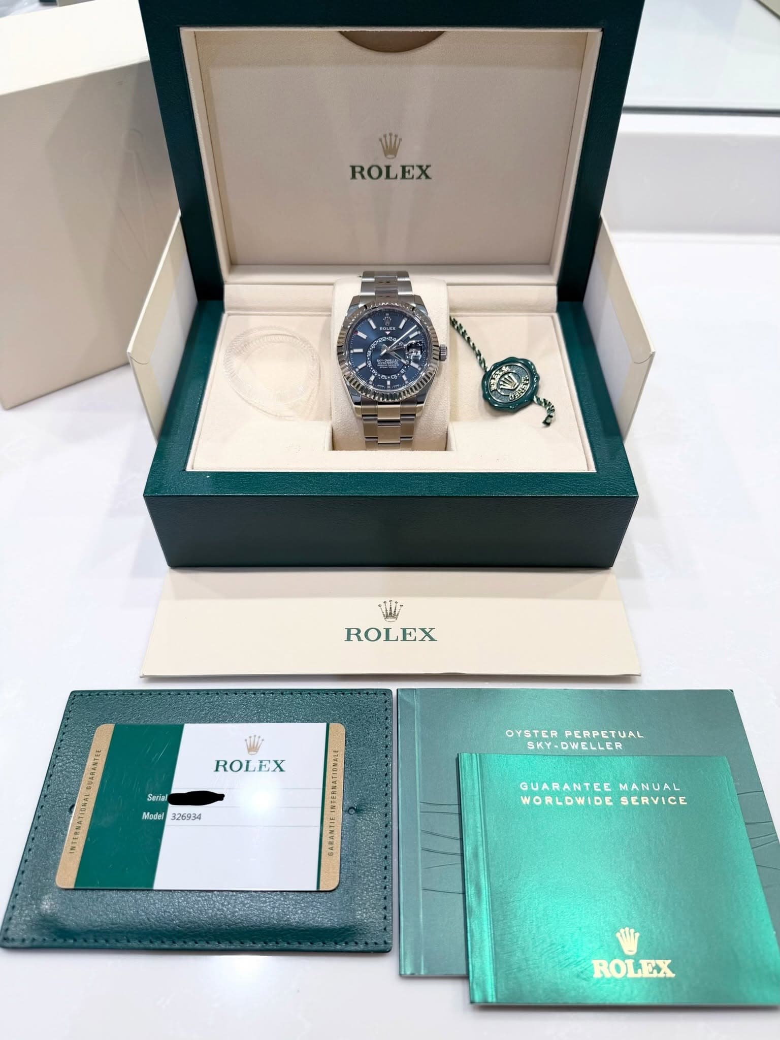 May be an image of wrist watch and text that says 'ROLEX “ልልጋያ ROLEX ROLEX GABANTCE RTEEVATI Sevlal Modal 326934 OYSTER PERPETUAL SRY-DWELLER OYSTERPERPETUAL SKY- WELLER GUARANTEE…