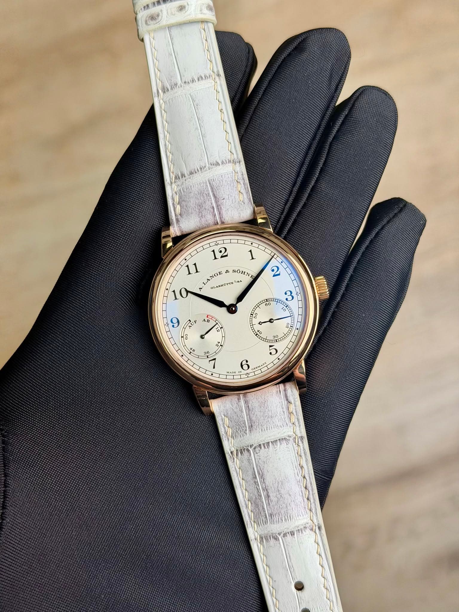May be an image of leather, wrist watch and text