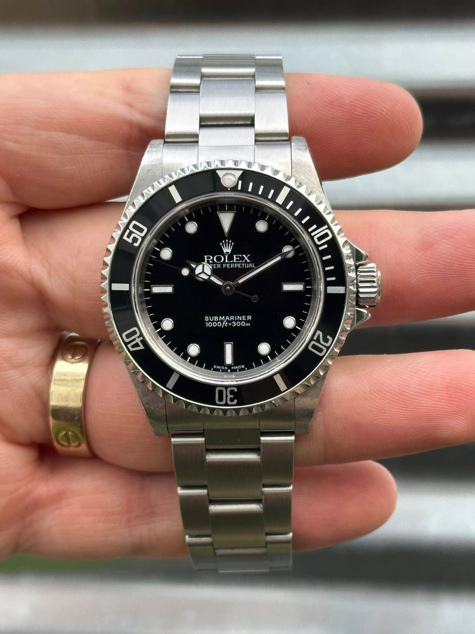 May be an image of wrist watch and text that says '50 ROLEX 5 PETI 10 SUBMARINE 1000ft= 000/t=300 300m 40 20 30'
