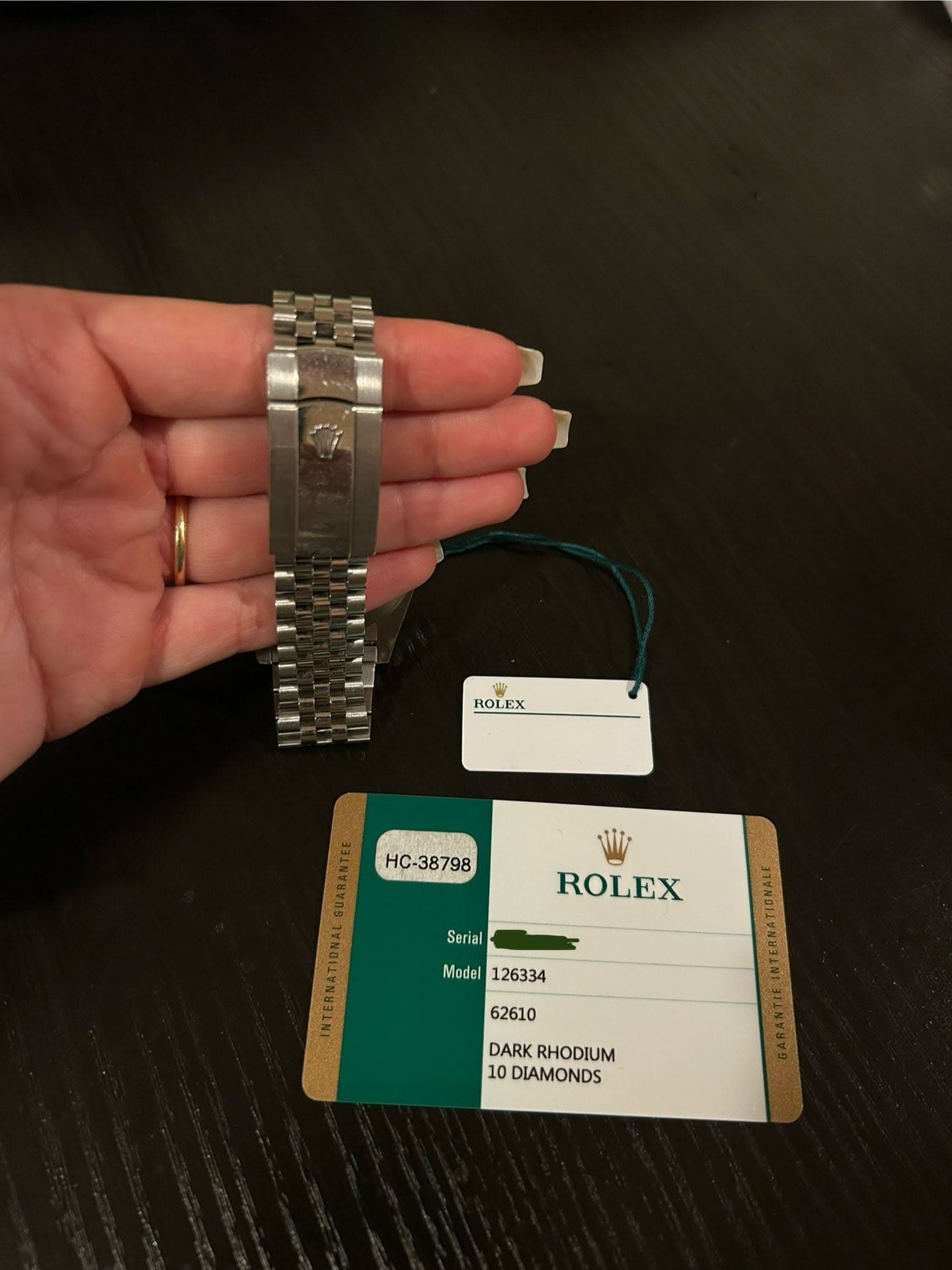 May be an image of digital watch and text that says 'ROLEX HC-38798 Serial ROLEX Model DARK ARKRHODIUM RHODIUM 10 DIAMONDS'