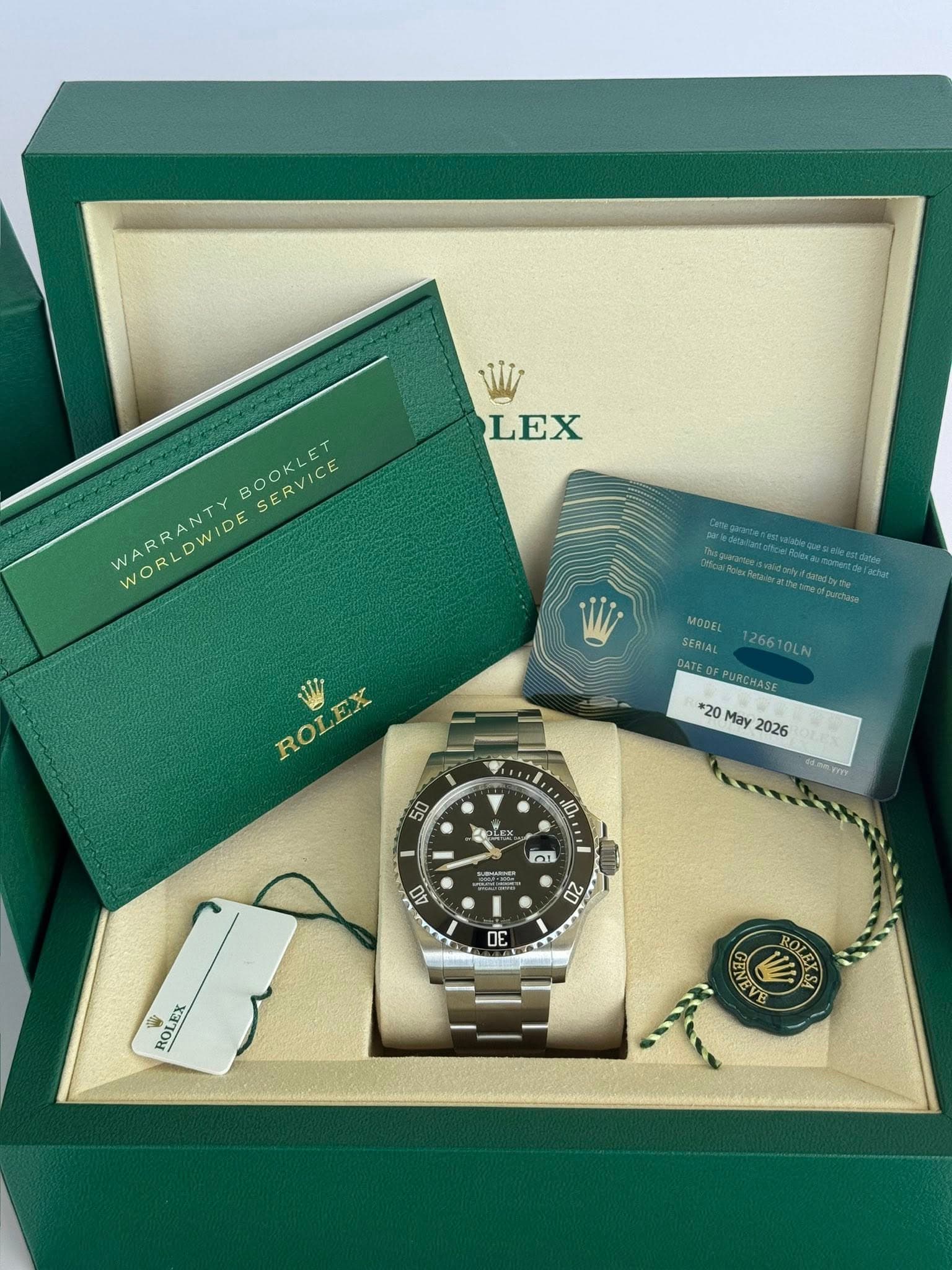 May be an image of wrist watch and text that says 'LEX BOOKLET SERVICE WARRANTY WORLDWIDE VIDE MODEL SERIAL 12661 26610LN OLN DATEO PURCHASE *20 May 2026 ROLEX 50 10 AO ก 02 OE ROL…