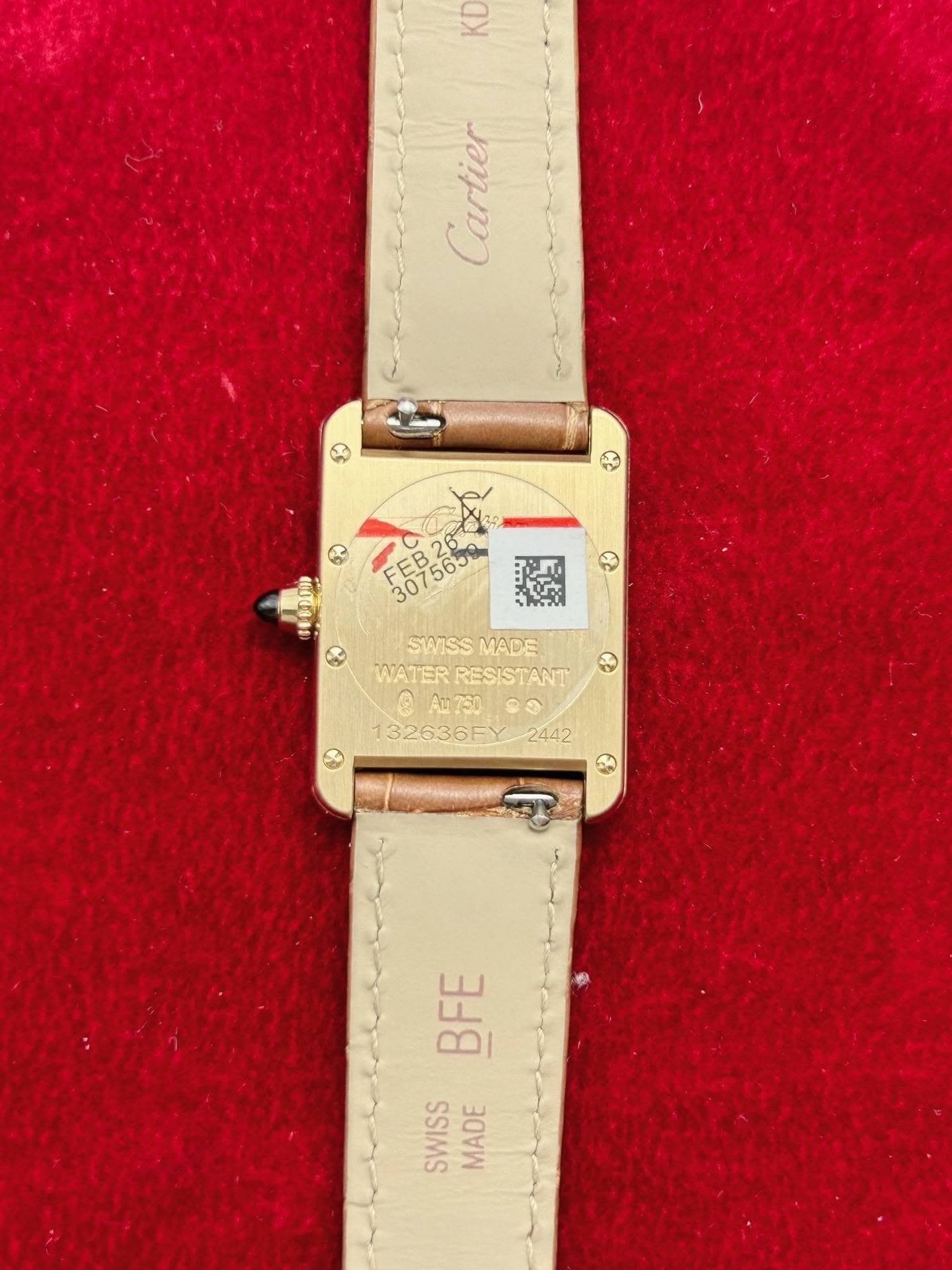 May be an image of wrist watch and text that says 'KD Cartier र 6ី6នី KA SWISS SWISSMADE MADE WATER RESISTANT ® 132636EY2442 2442 132636F 福 BFE SWISS MADE MADE'