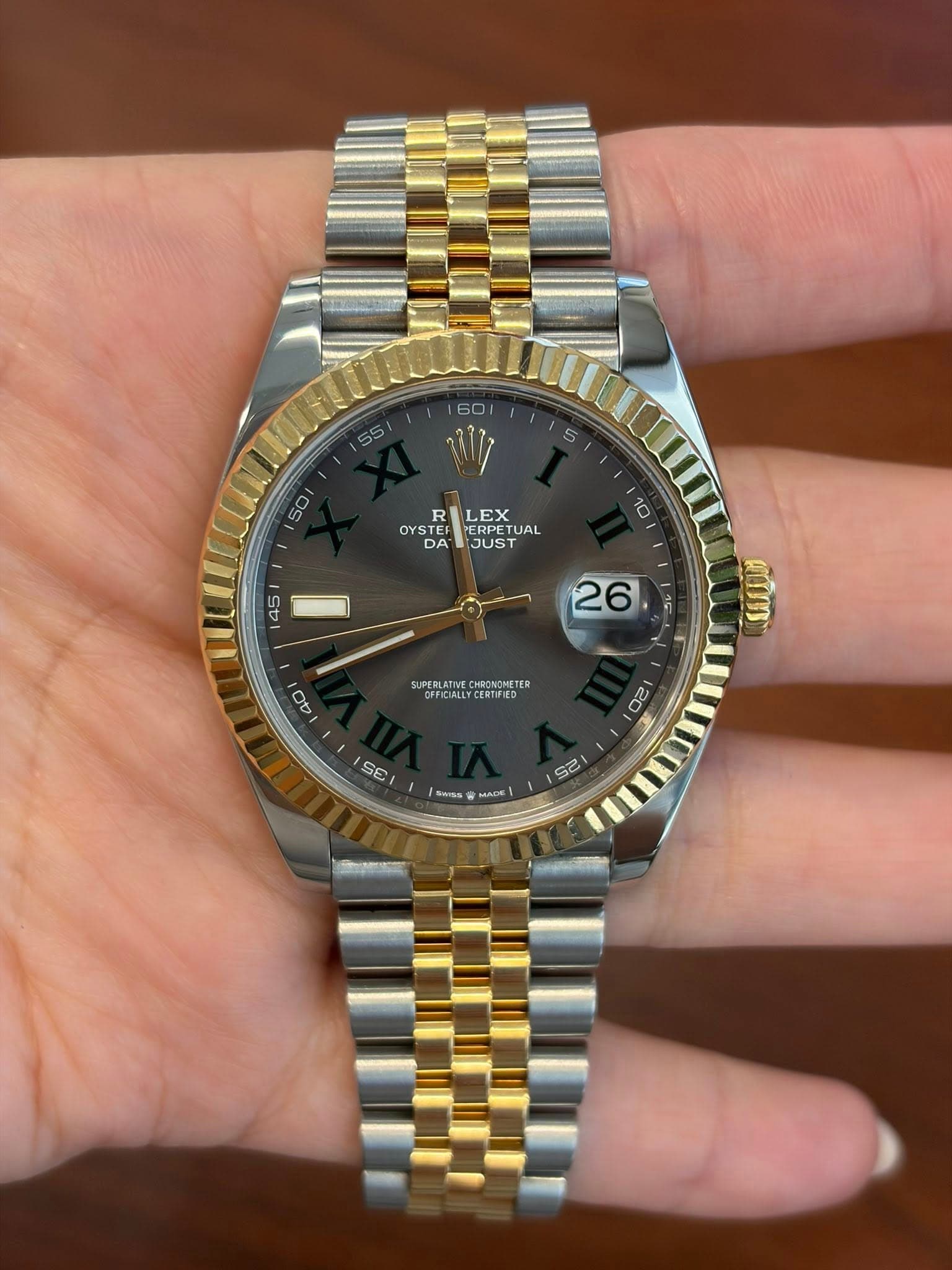 May be an image of wrist watch and text
