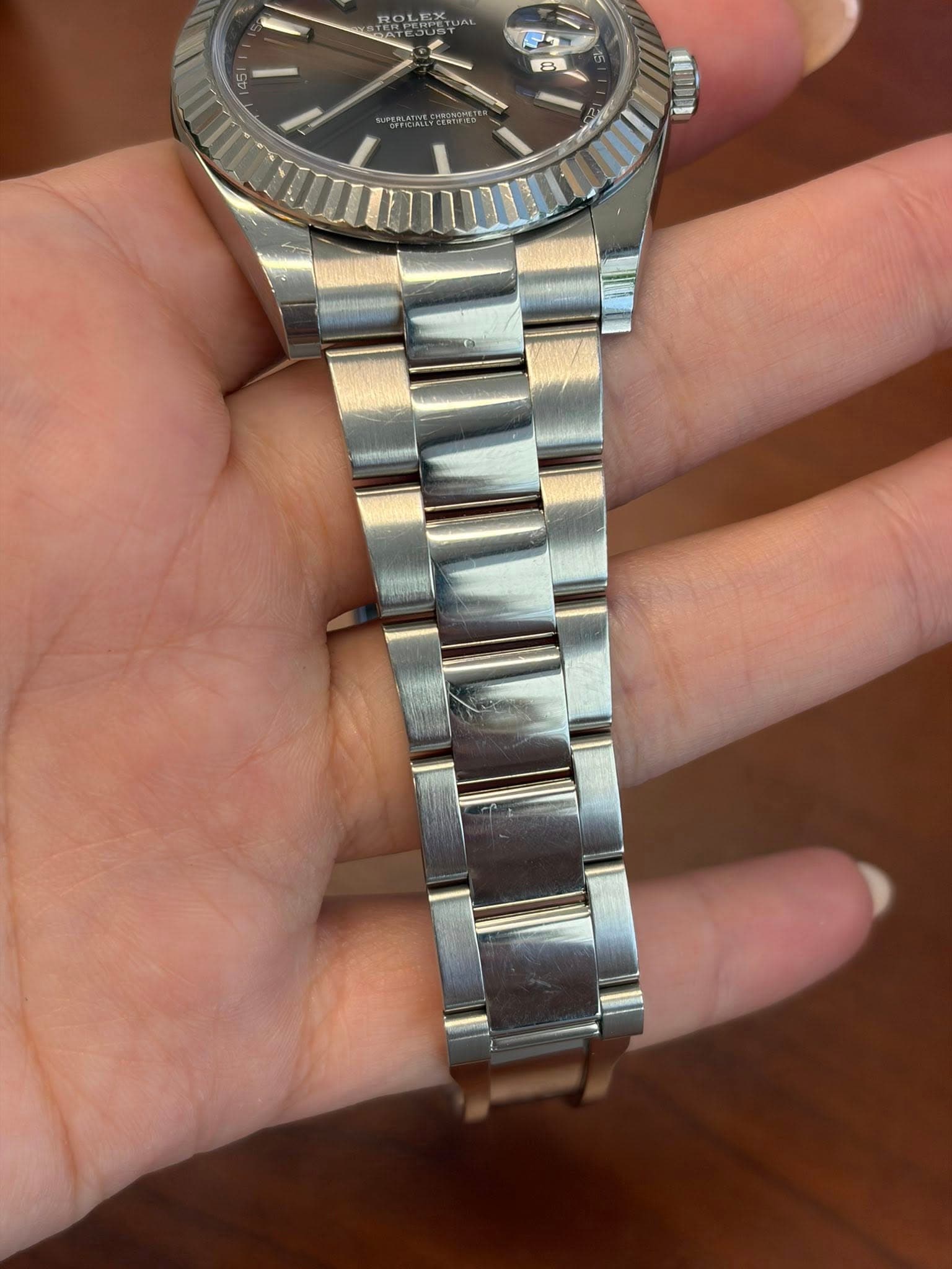 May be an image of wrist watch and text