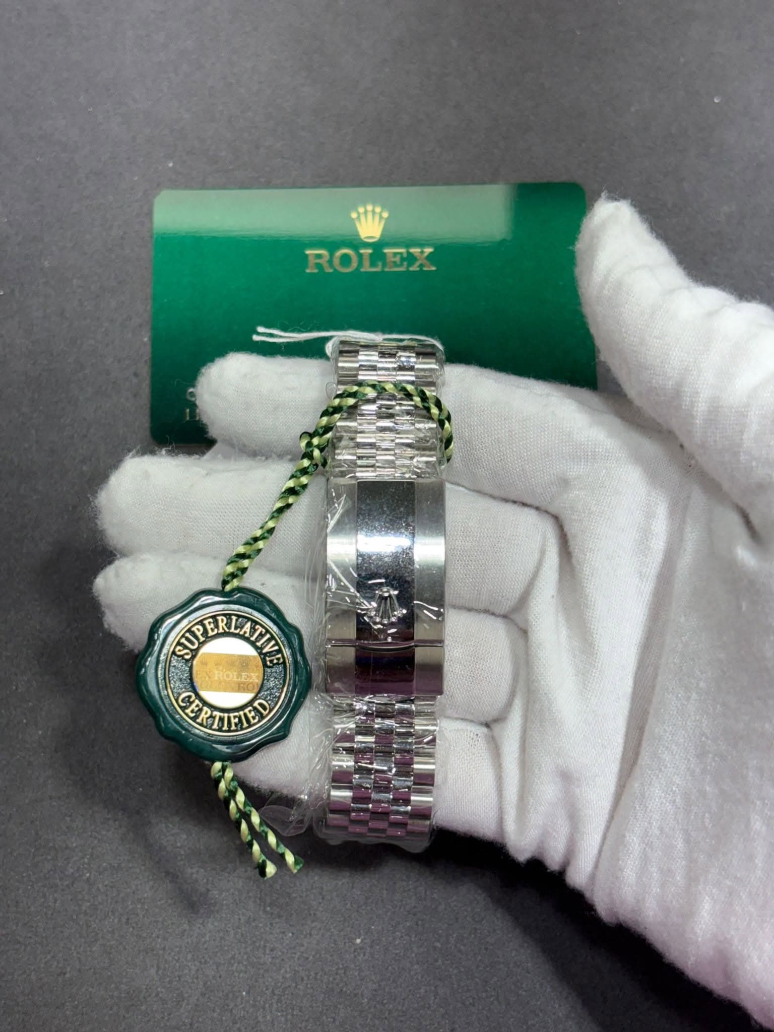 May be an image of wrist watch and text that says 'ROLEX ROLEX SUP SUPERLA SUPERIATIE ERLA 2 EX CERTIFTED E RTIFIE'