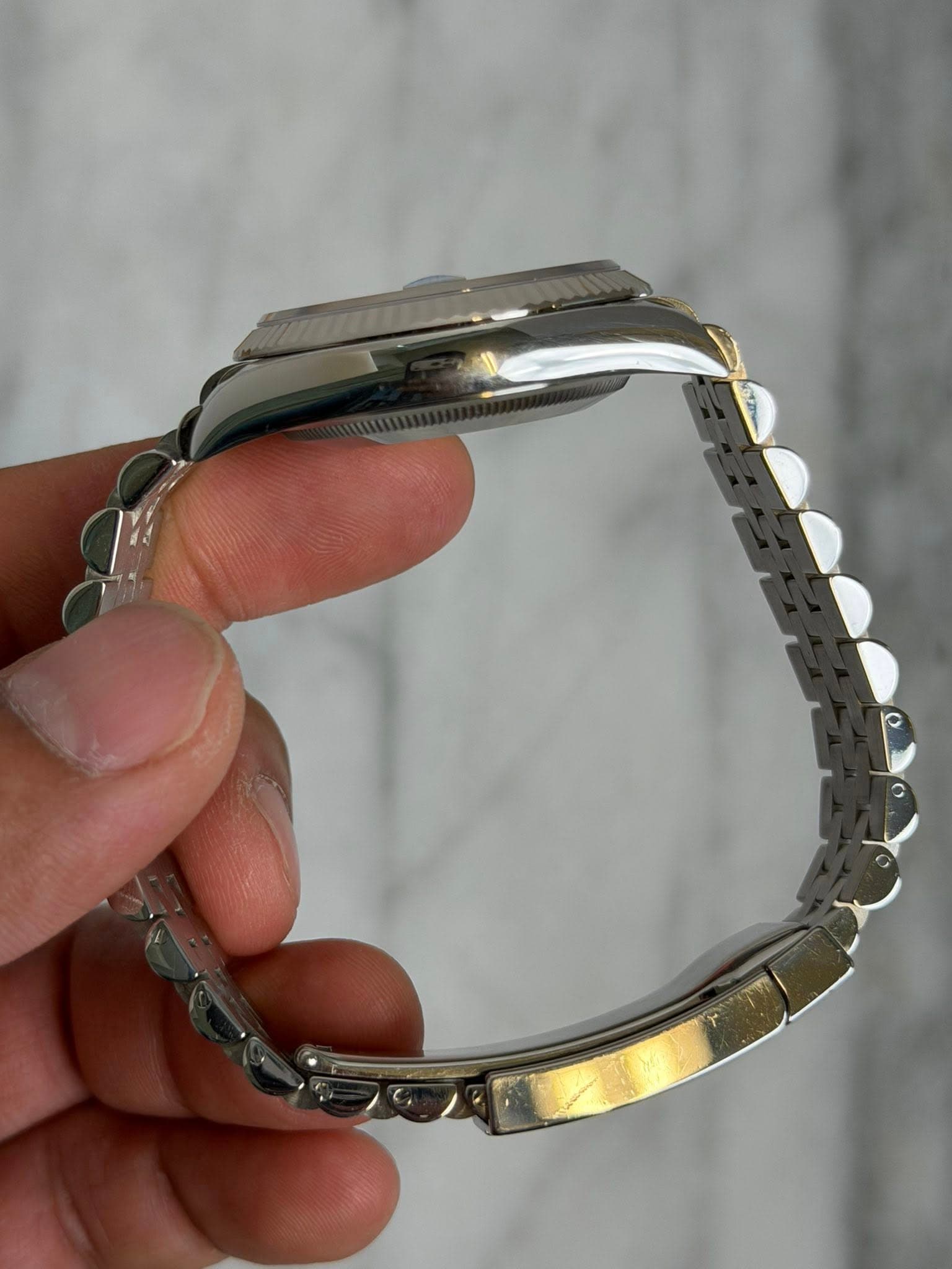 May be an image of wrist watch and jewelry