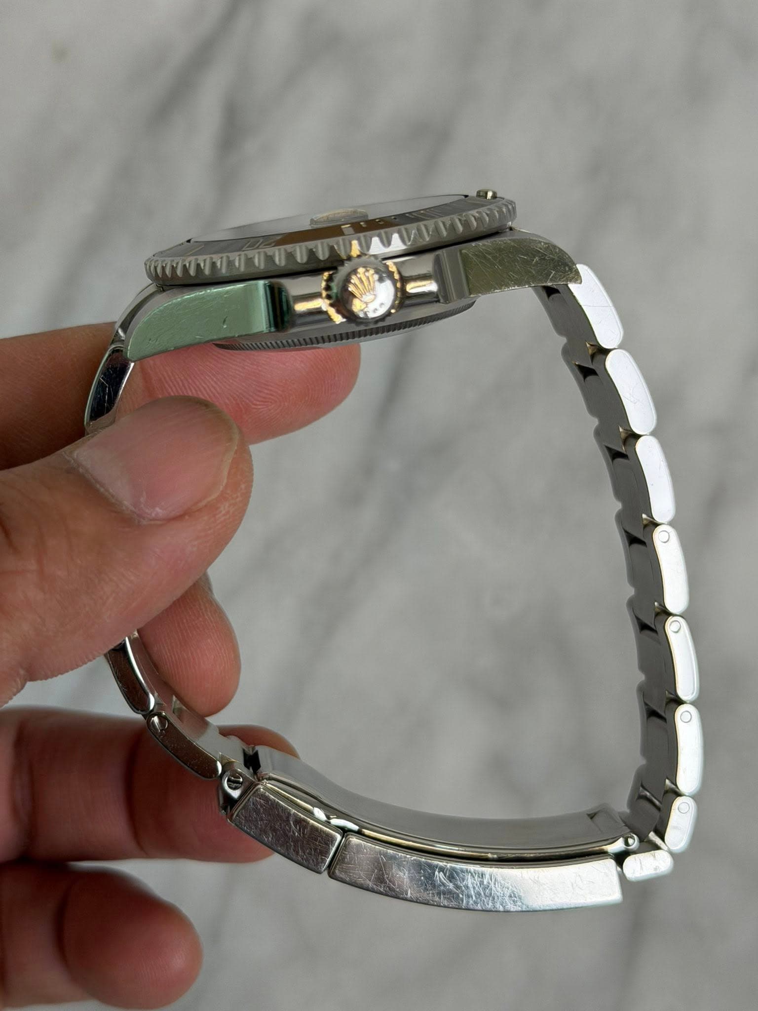 May be an image of jewelry, wrist watch and text