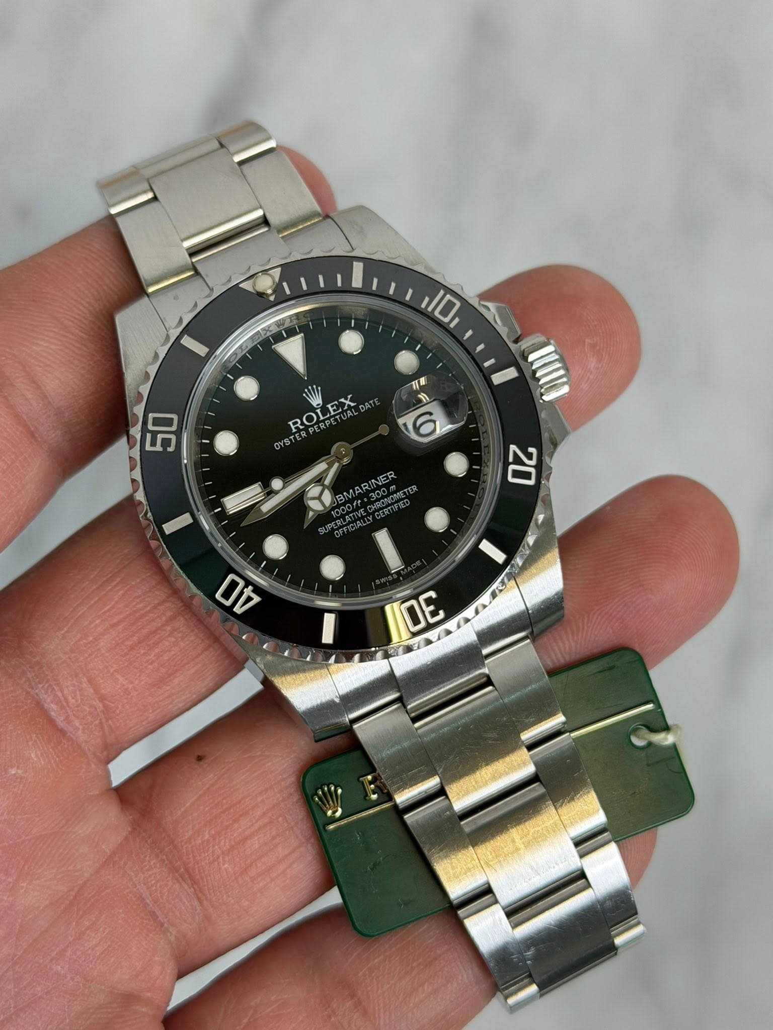 May be an image of wrist watch and text that says '風 10 ዘር 50 ROLEX ROLEX ROL 6 20 04 0E E'