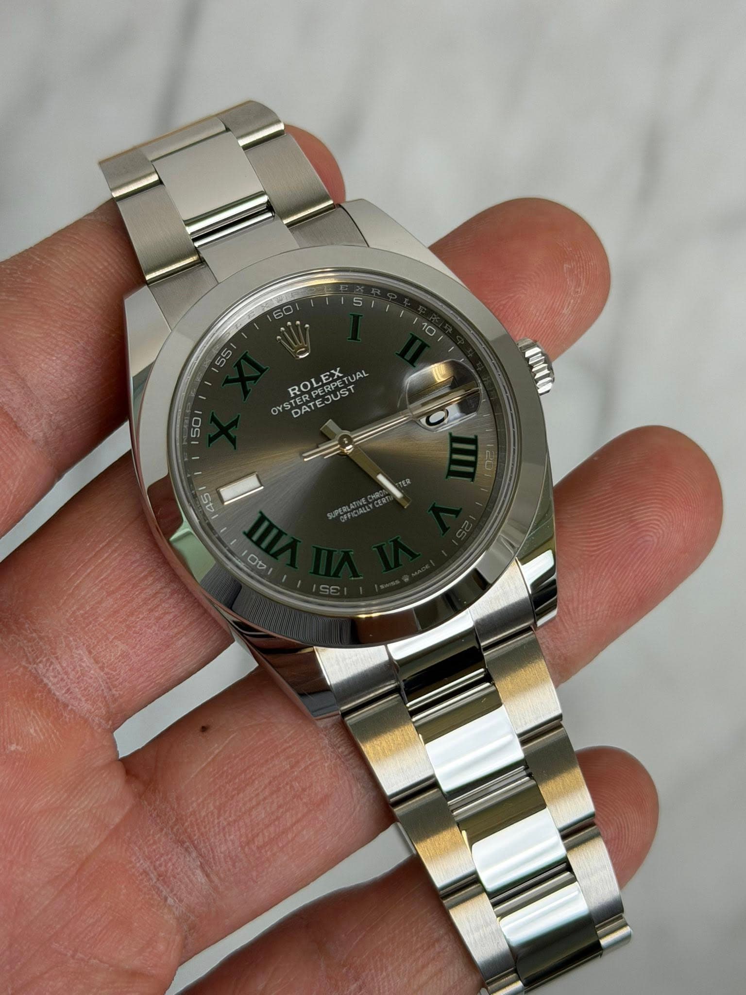 May be an image of wrist watch and text that says 'ROLEX JAL JUST US DAT DATE AT 50 45 00'
