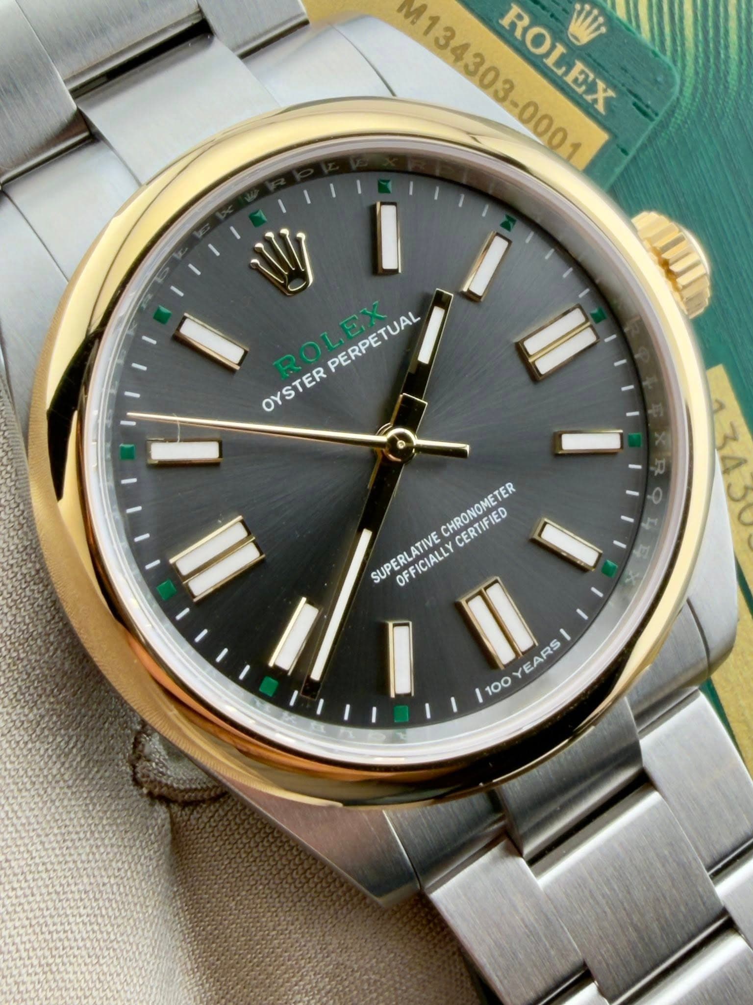 May be an image of wrist watch and text that says 'M134303-0001 ROLEX PO6PX 1 I PERPETUAL PERPETUAL OYSTER I CHRONOMETER CERTIFIED SUPERLATIVE OFFICIALLY I II EARS 100'
