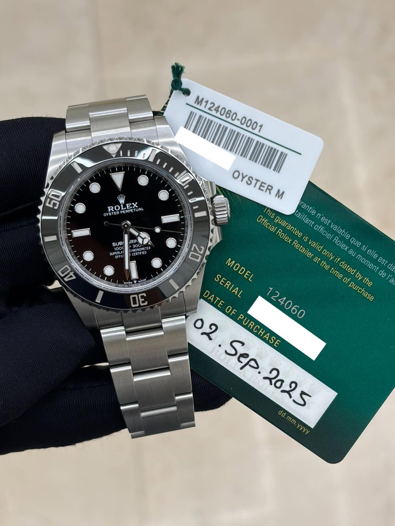 May be an image of wrist watch and text that says 'M124060-000 M124060-0001 50 JO ROLEX DPETUAL PERPE y00 SUBI DEBLAT SPERLET SEGFER 40 OYSTER M This Official Rolex guarantee…