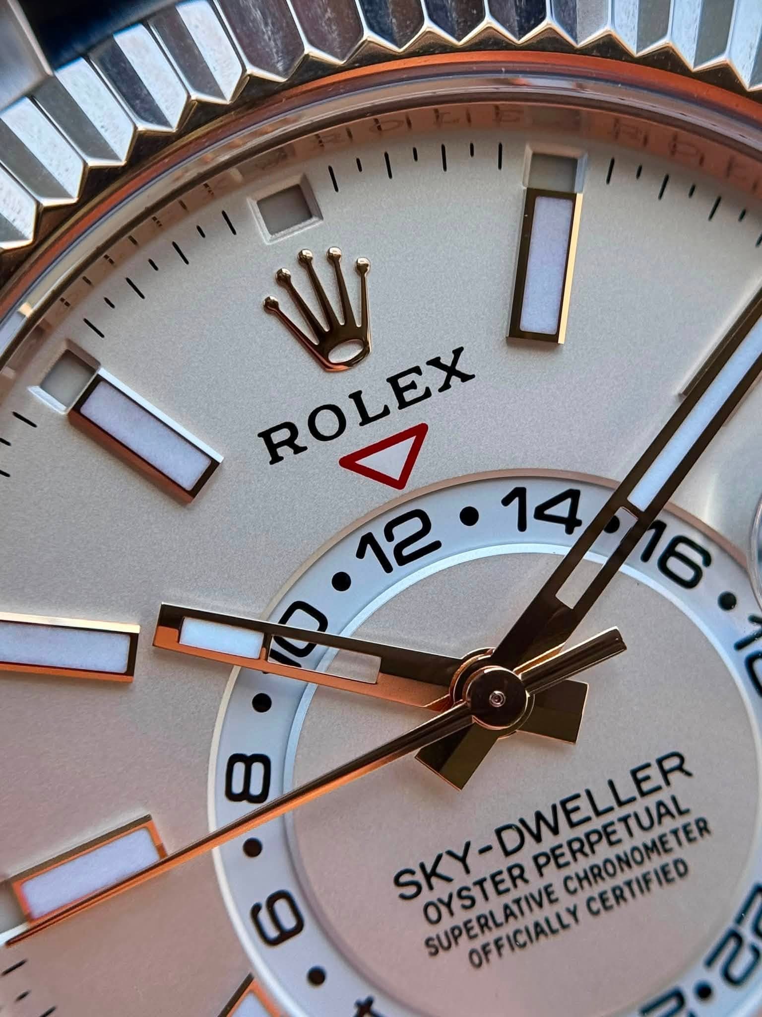 May be an image of wrist watch and text that says 'y ROLEX ROLEX B 0 SKY- OYSTER SUPERLATIVE SKY-DWELLER CHRONOMETER CERTIFIED CERTIFIED PERPETUATE PERPETUAL OFFICIALLY'