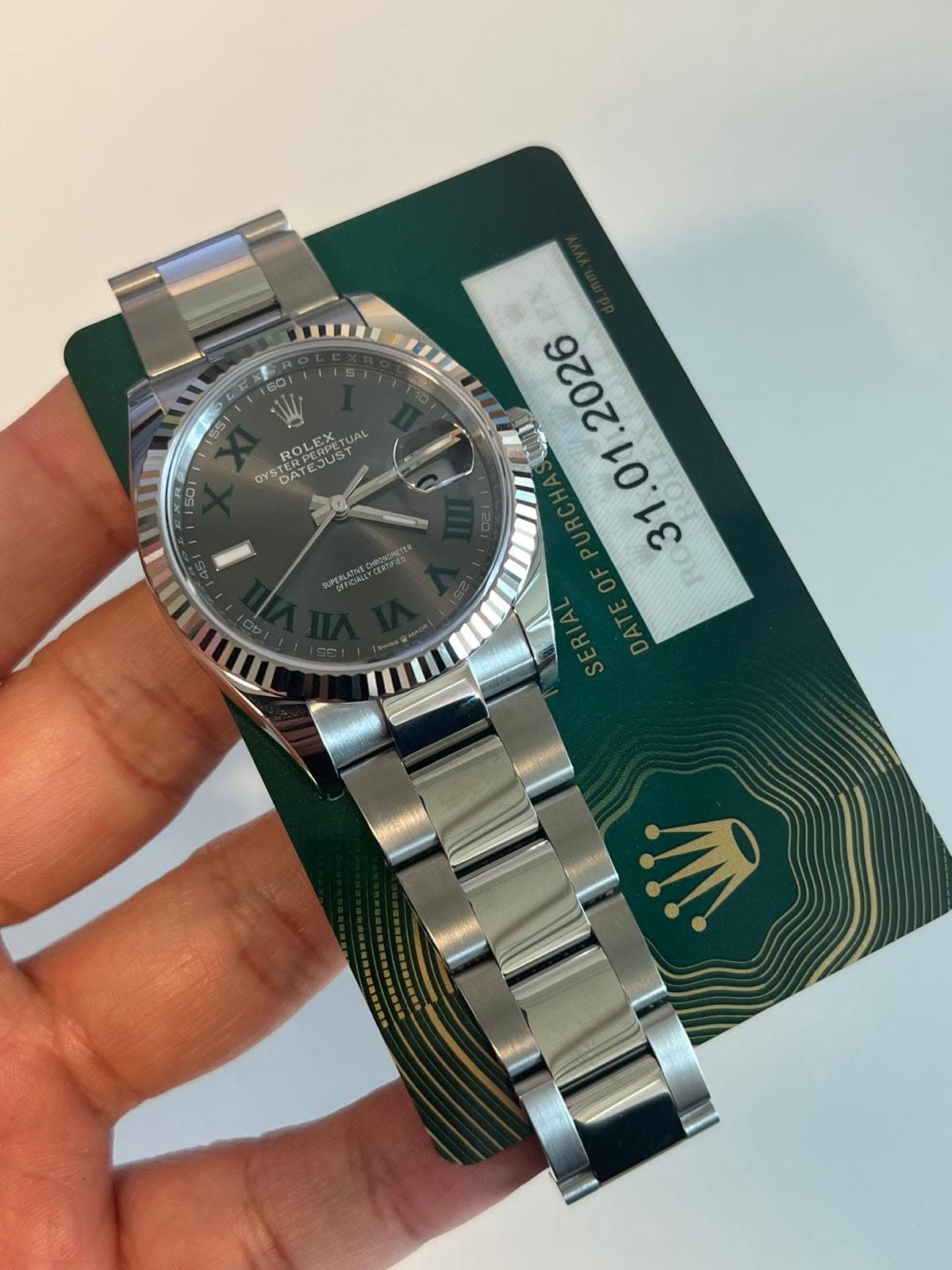 May be an image of wrist watch and text