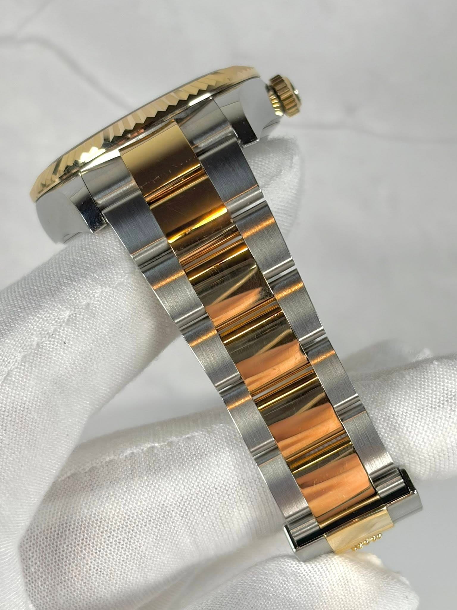 May be an image of jewelry, wrist watch and text