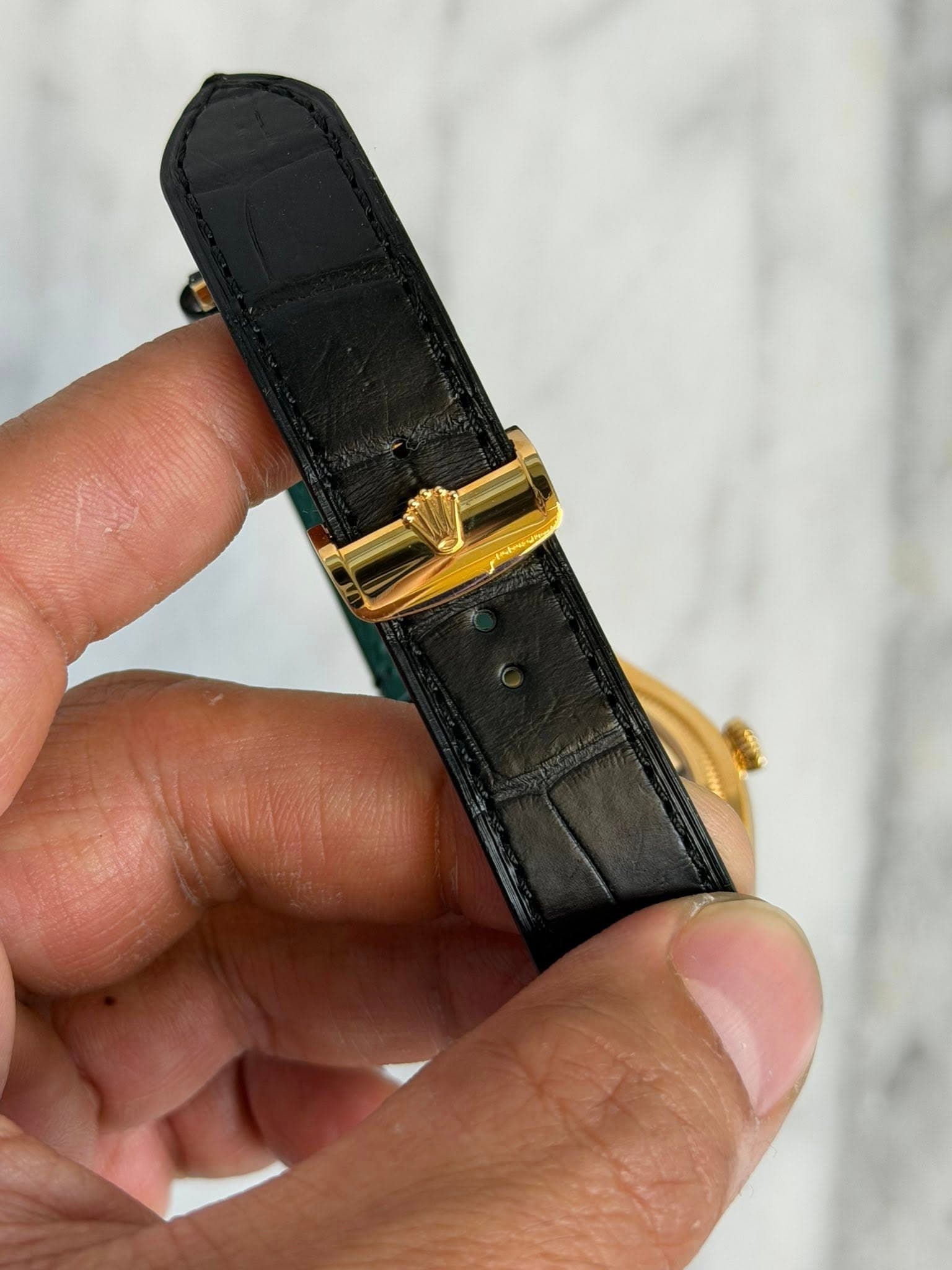 May be an image of saddle-stitched leather and wrist watch