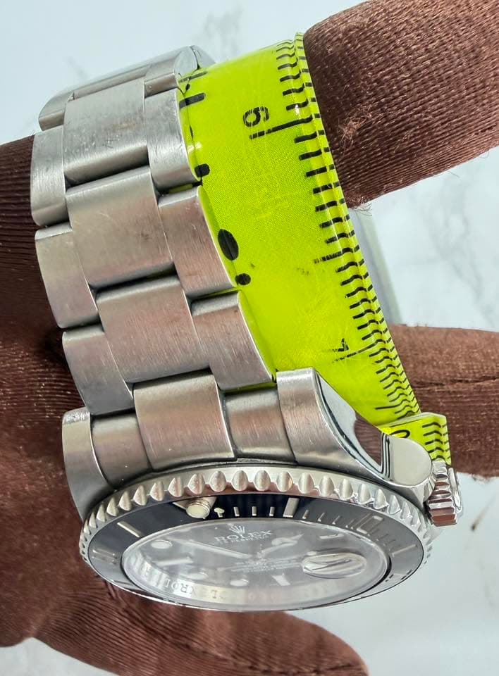 May be an image of measuring stick, wrist watch and text