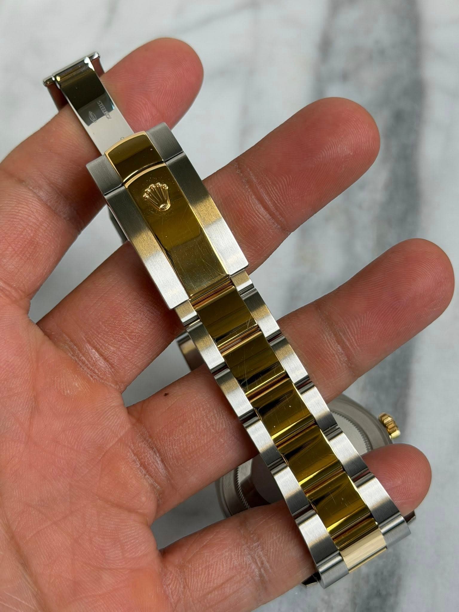 May be an image of jewelry and wrist watch