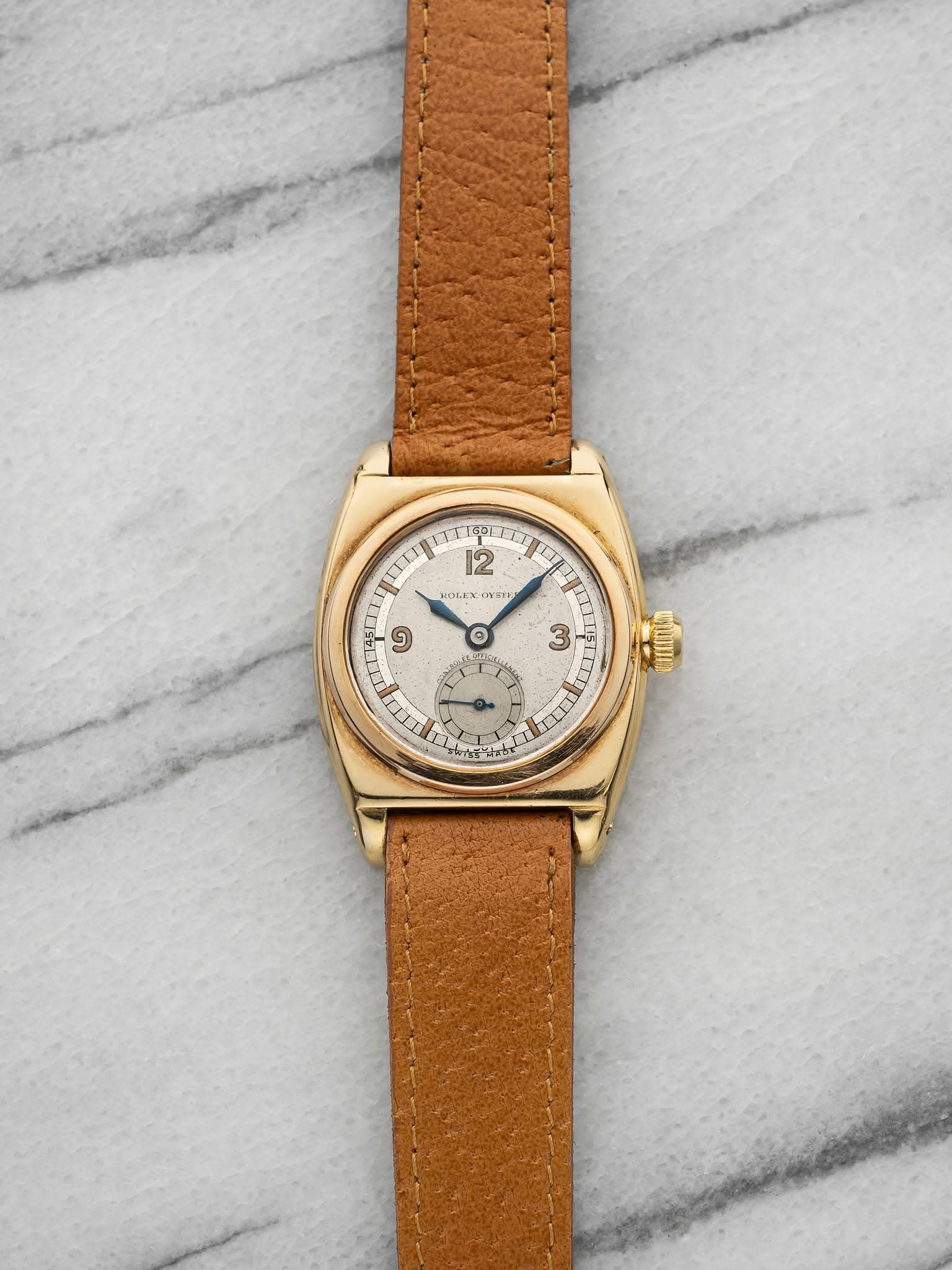 May be an image of leather, wrist watch and text