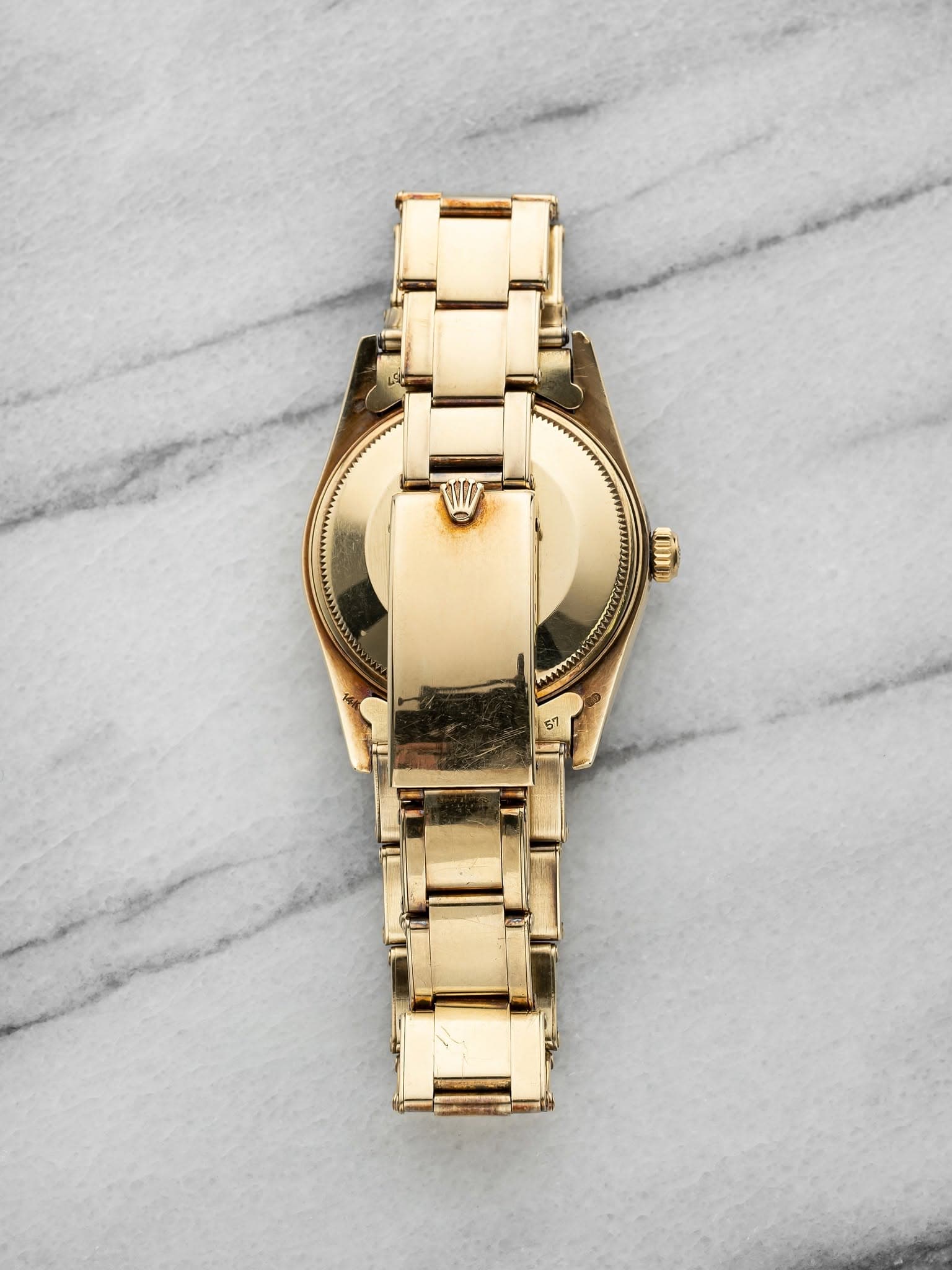 May be an image of jewelry, wrist watch and text
