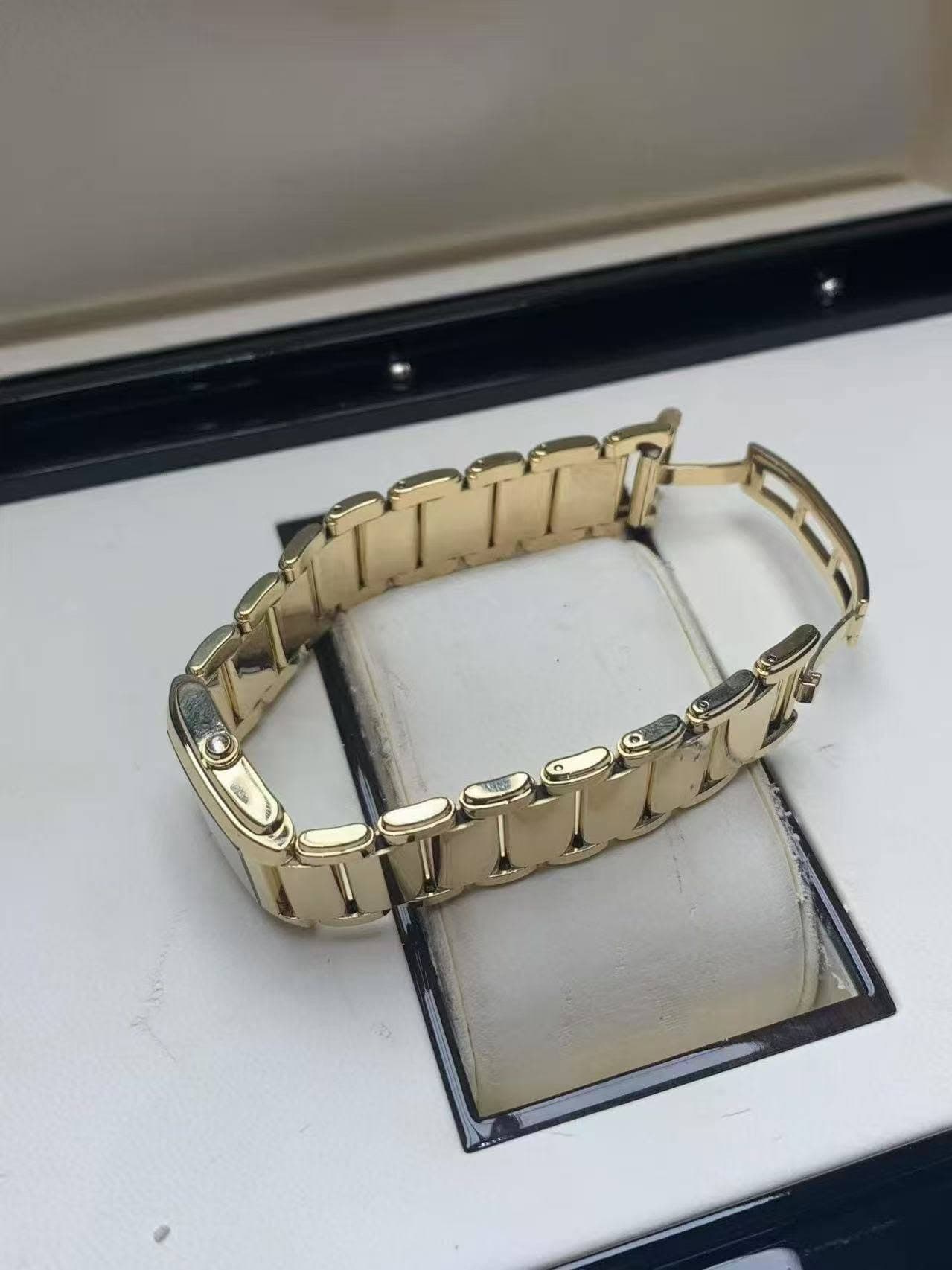 May be an image of wrist watch, jewelry and text