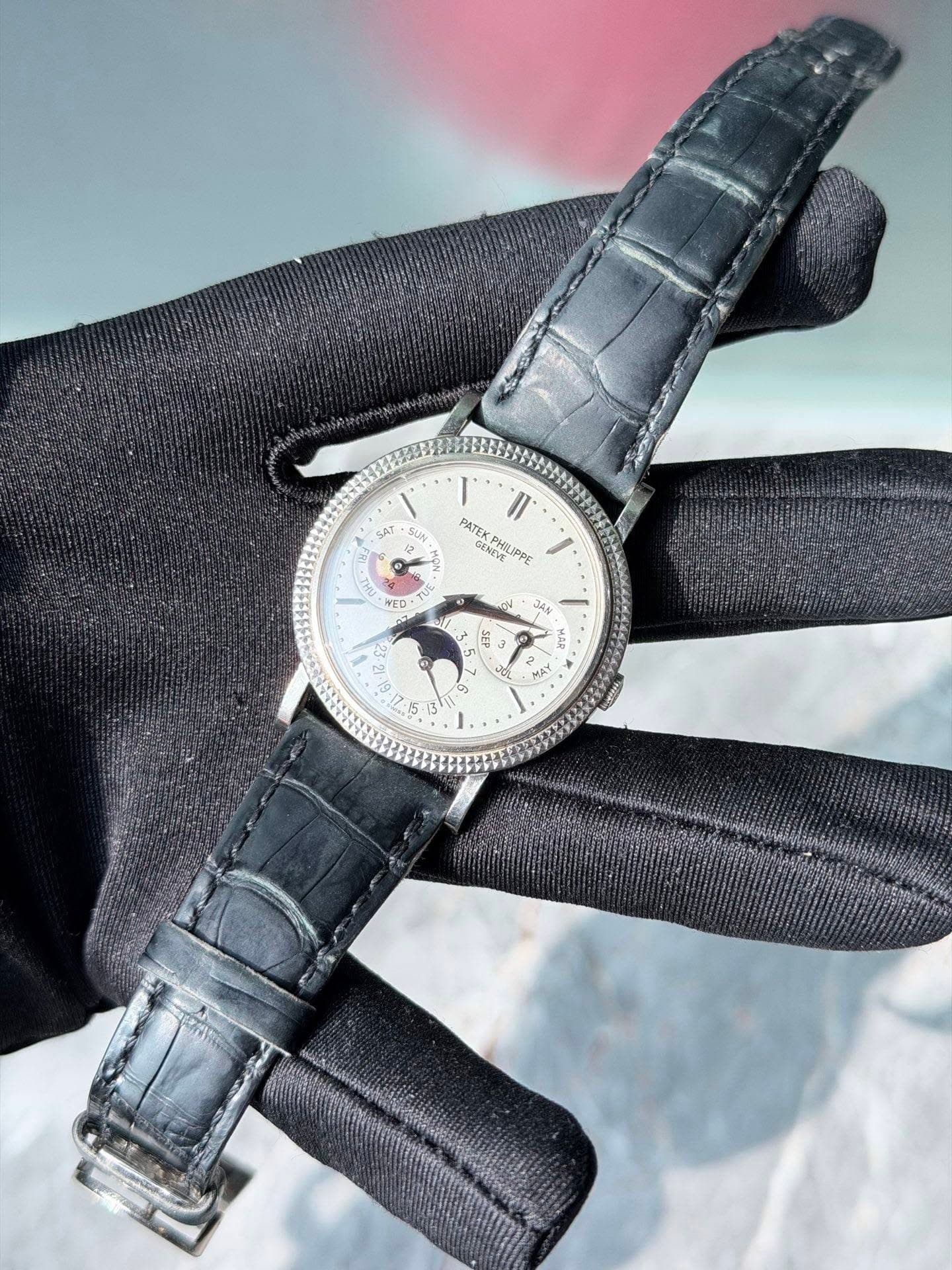 May be an image of leather, wrist watch and text