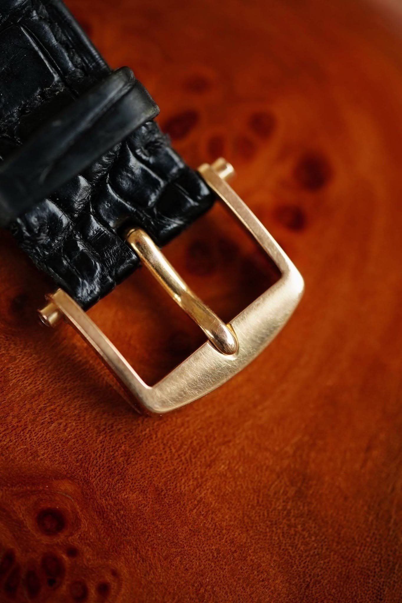 May be an image of saddle-stitched leather, brass, wrist watch and leather