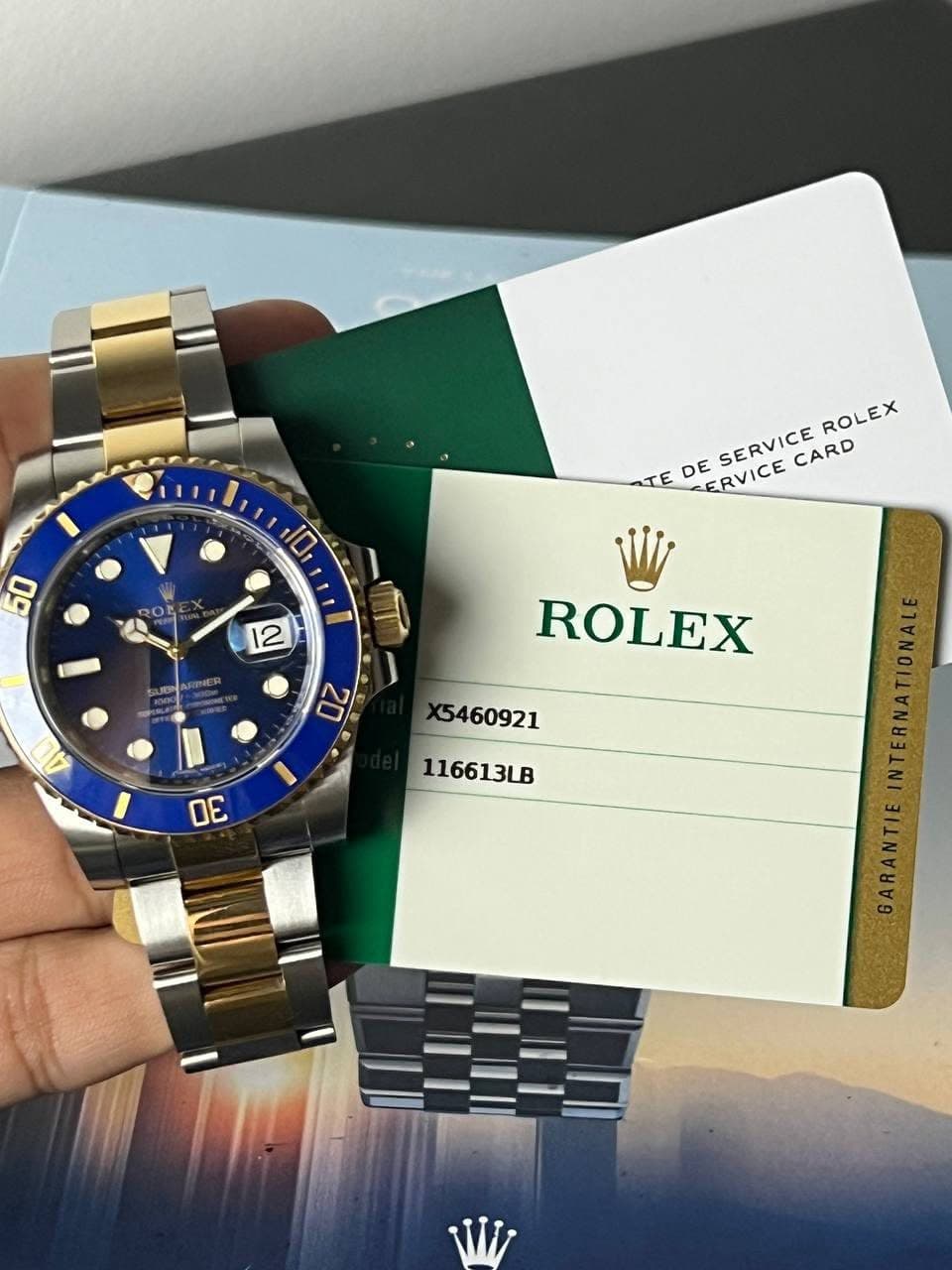 May be an image of wrist watch and text that says '50 10 ROLEX DE SERVICE co SERVICE CARD TE ERVICE 12 A 20 ROLEX X5460921 116613B W'